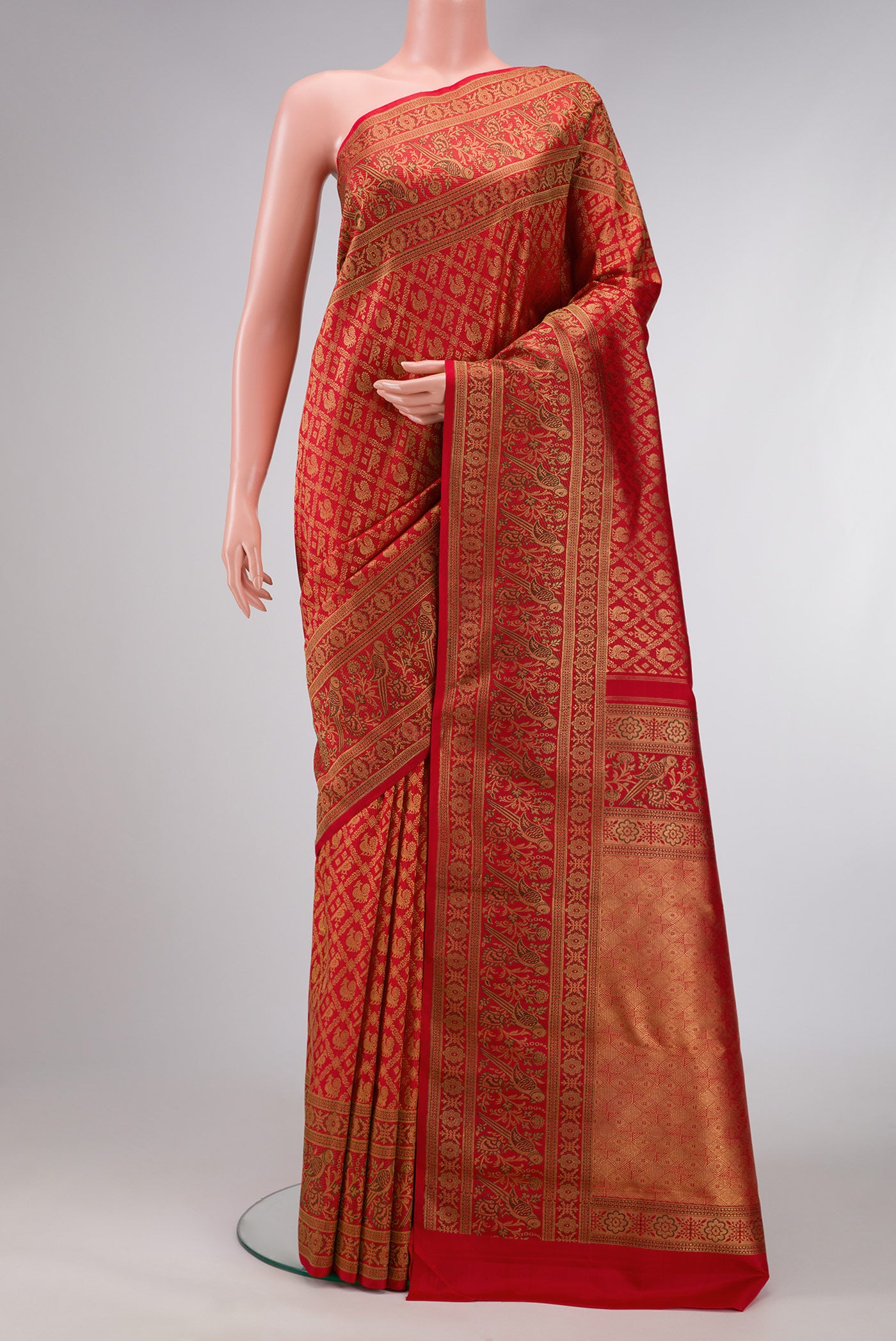 Pure Silk Pure Zari Red Dual Tone Kanjivaram Saree with Zari Brocade on the body and Zari Border.  displayed on a mannequin