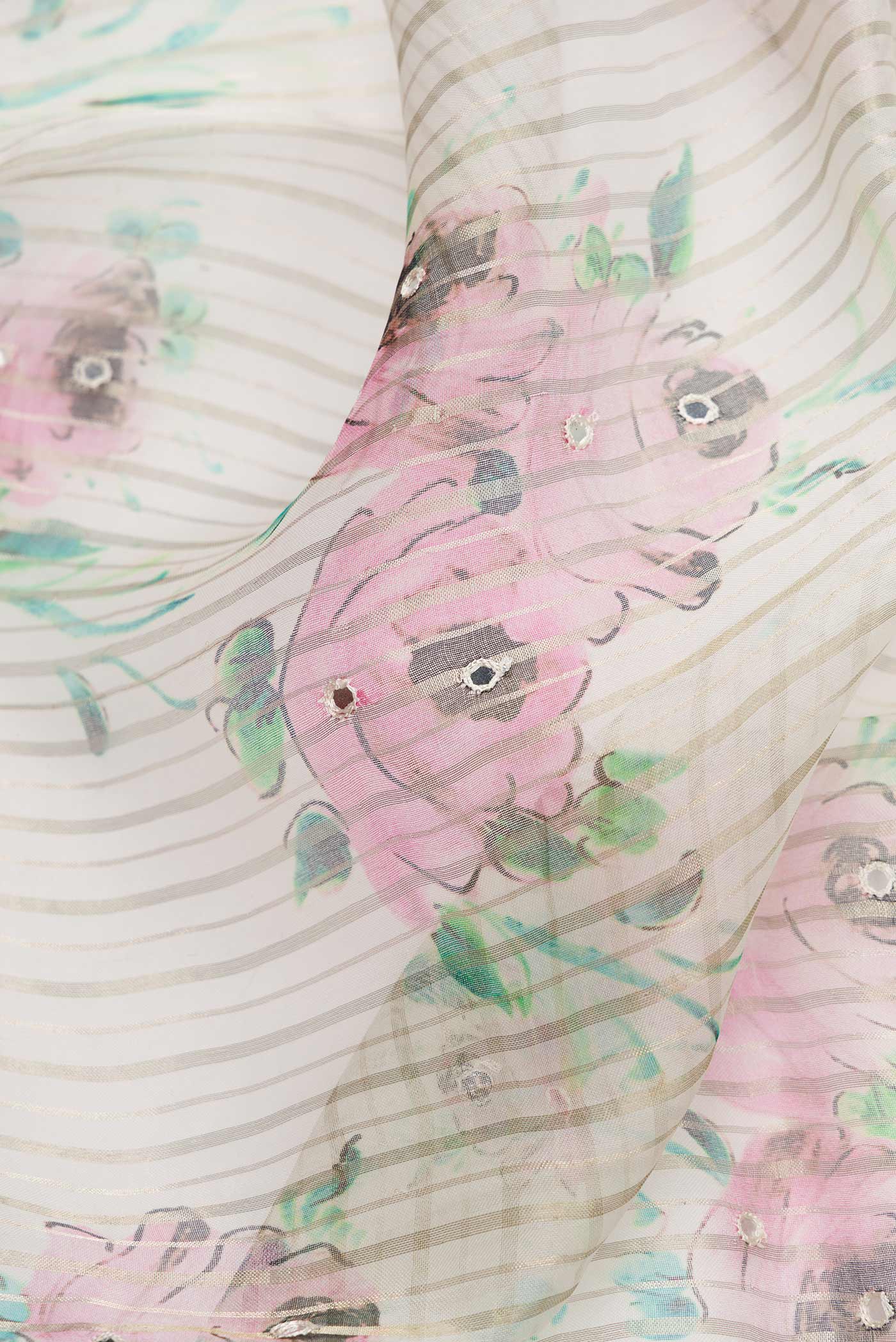 Close up of Off White Dual Tone Organza Silk Saree with Printed design on the body and Embroidery Border.  displaying folds