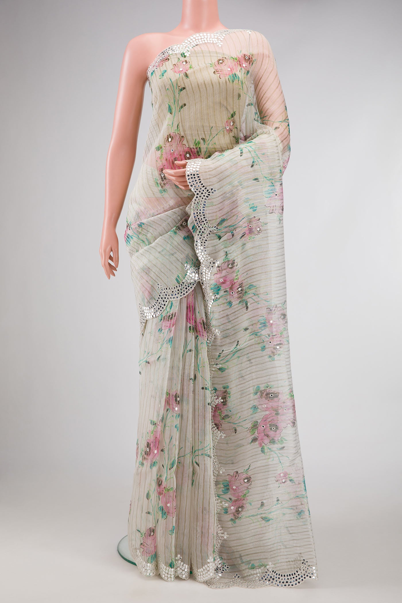 Off White Dual Tone Organza Silk Saree with Printed design on the body and Embroidery Border.  displayed on a mannequin