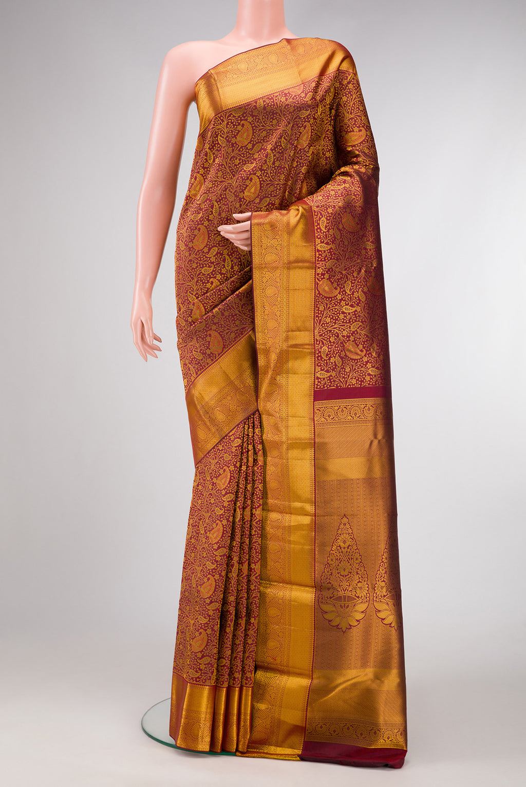 Maroon Dual Tone Kanjivaram Silk Saree with Zari Brocade on the body and Zari Border.  displayed on a mannequin