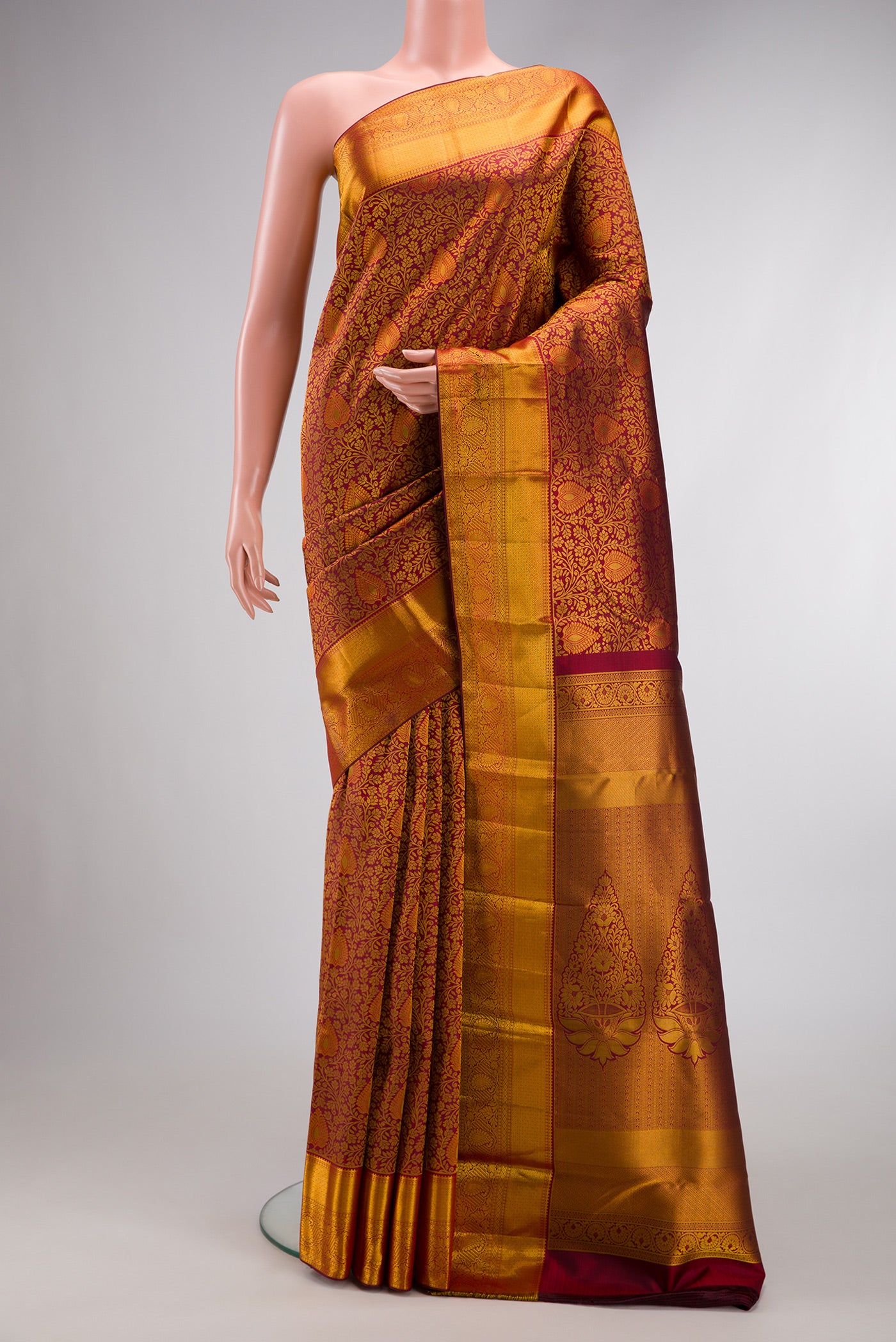Maroon Dual Tone Kanjivaram Silk Saree with Zari Brocade on the body and Zari Border.  displayed on a mannequin