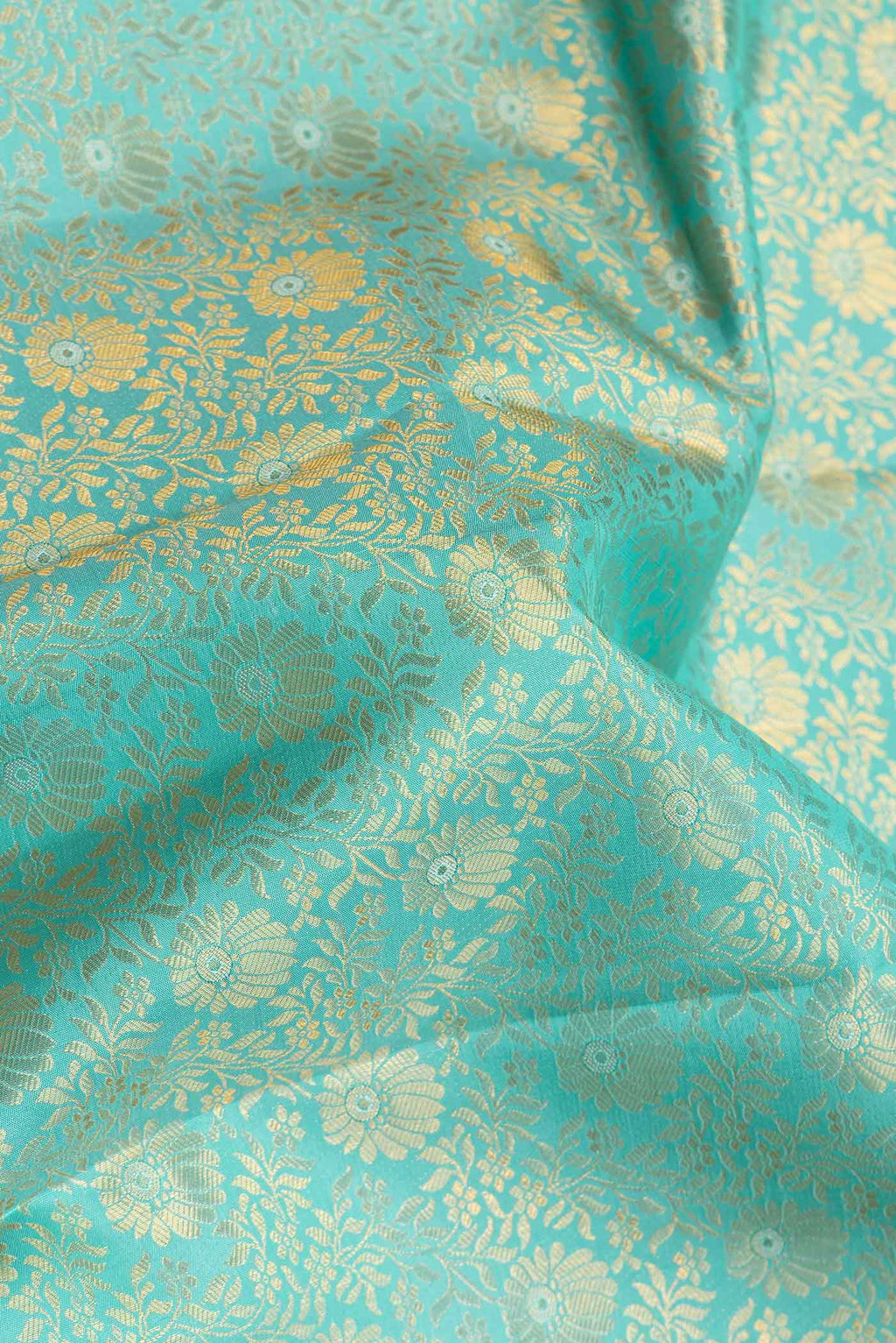 Close up of Sea Green Dual Tone Kanchipuram Silk Saree with Zari Brocade on the body and Zari Border.  displaying folds