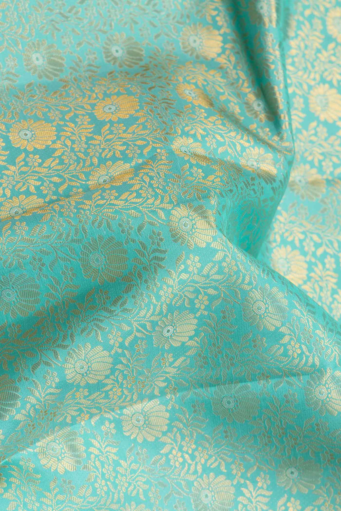 Close up of Sea Green Dual Tone Kanchipuram Silk Saree with Zari Brocade on the body and Zari Border.  displaying folds