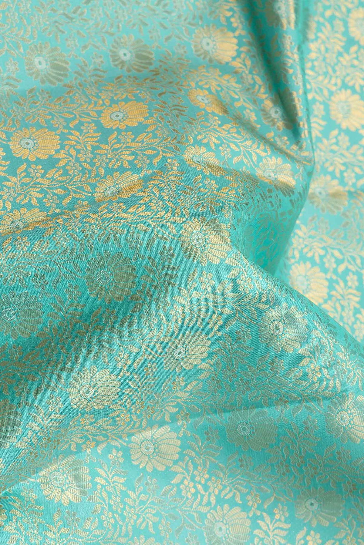 Close up of Sea Green Dual Tone Kanchipuram Silk Saree with Zari Brocade on the body and Zari Border.  displaying folds