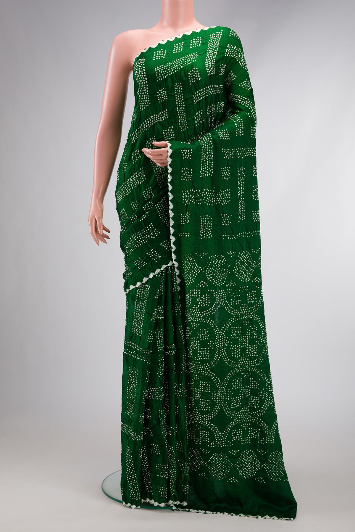 Bottle Green Dual Tone Bandhani Silk Saree with Printed design on the body and Printed Border.  displayed on a mannequin