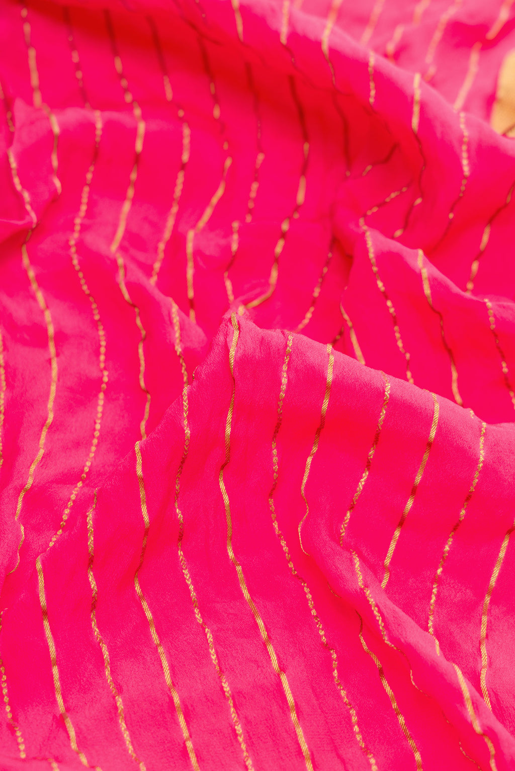 Close up of Pink Dual Tone Bandhani Silk Saree with Bandhani Print on the body and Zari Border.  displaying folds
