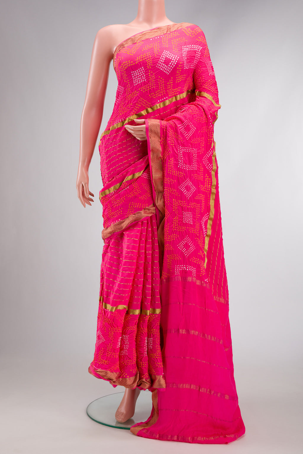 Pink Dual Tone Bandhani Silk Saree with Bandhani Print on the body and Zari Border.  displayed on a mannequin