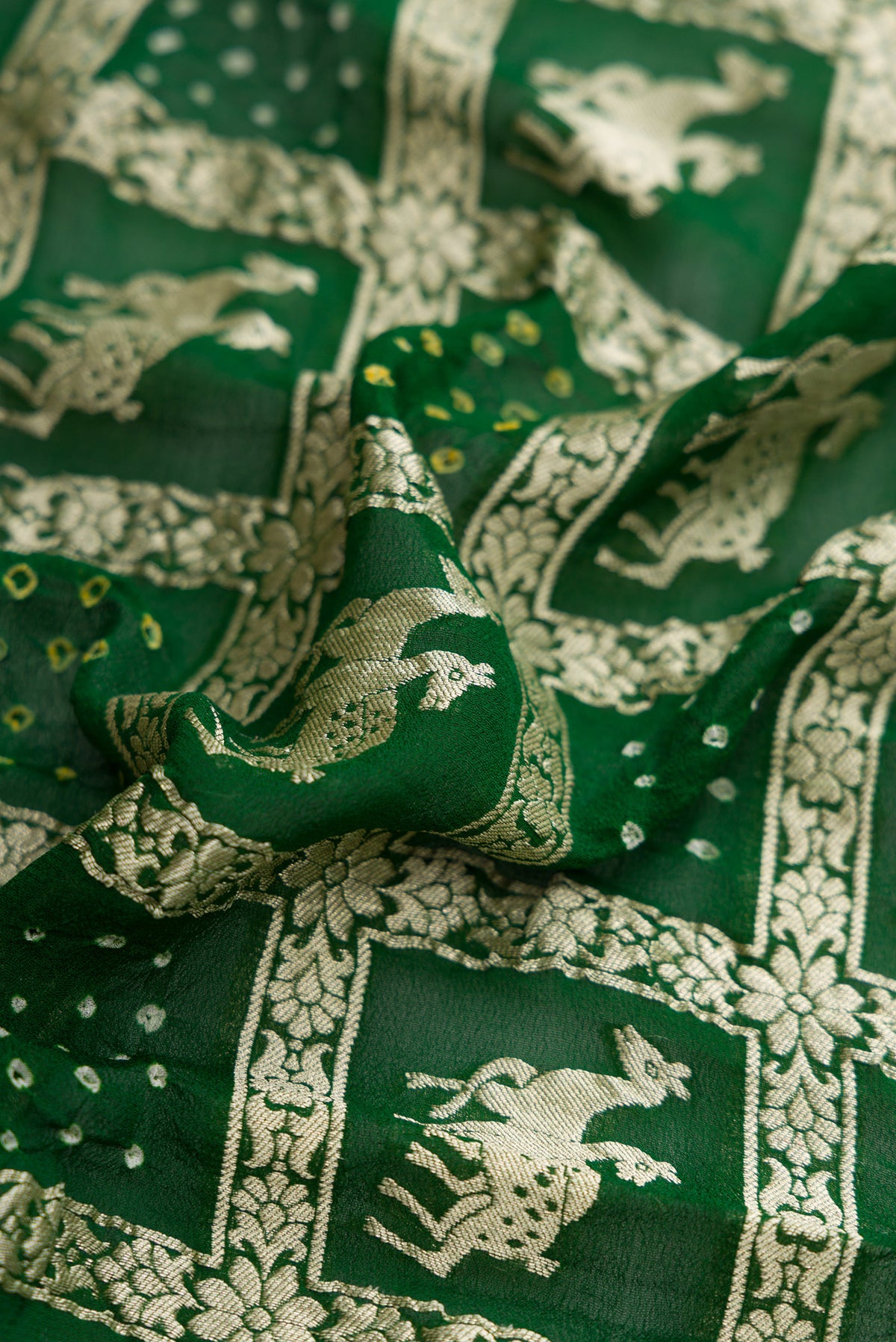 Close up of Bottle Green Dual Tone Banarasi Georgette Saree with Zari Brocade on the body and Zari Border.  displaying folds