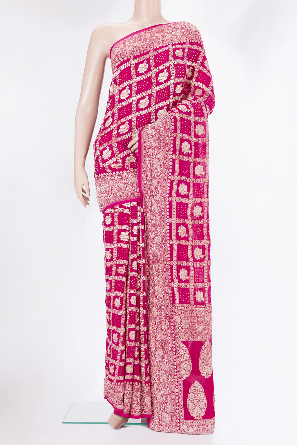 Dark Pink Bandhani Georgette Saree with Zari Brocade on the body and Zari Border.  displayed on a mannequin