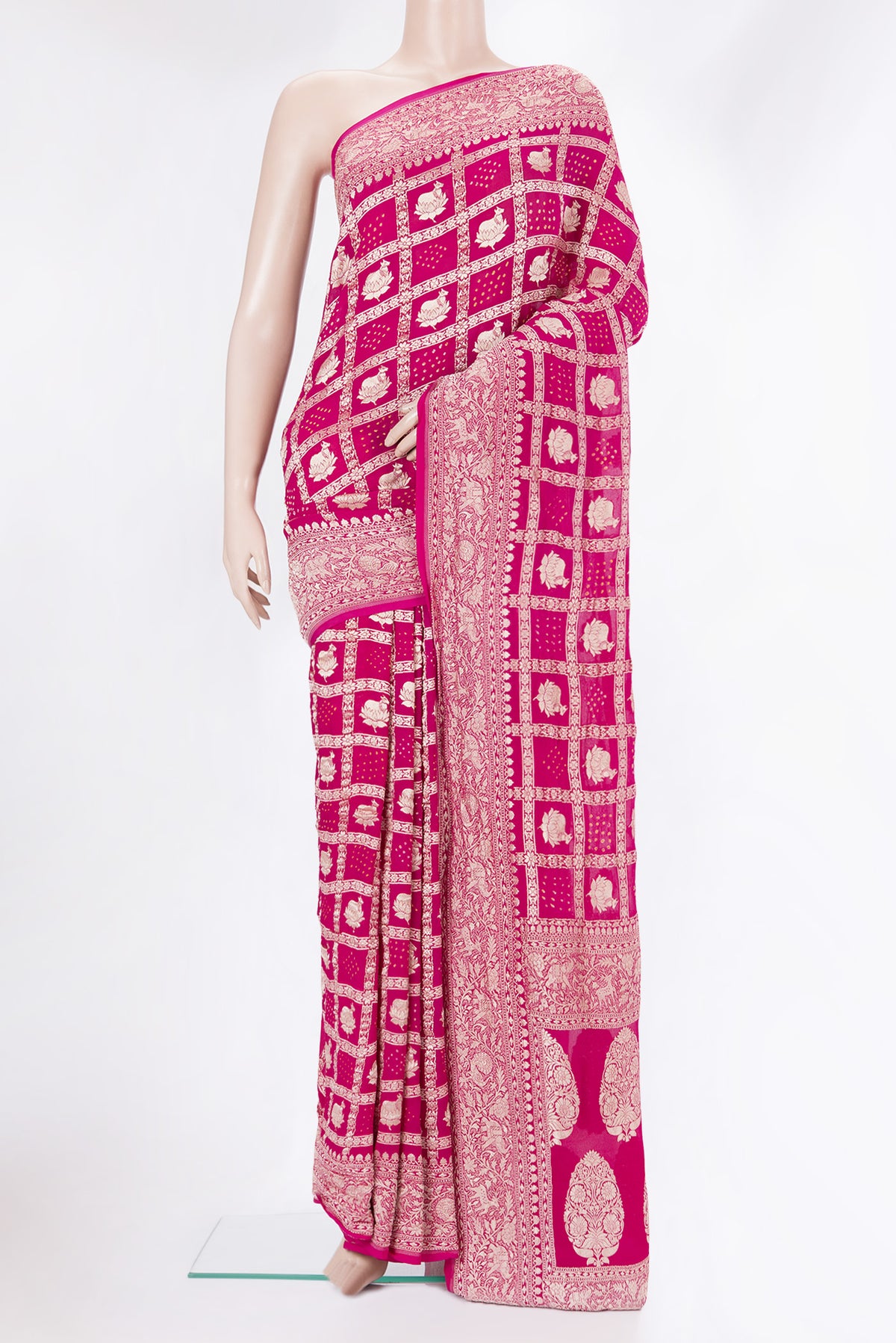 Dark Pink Bandhani Georgette Saree with Zari Brocade on the body and Zari Border.  displayed on a mannequin