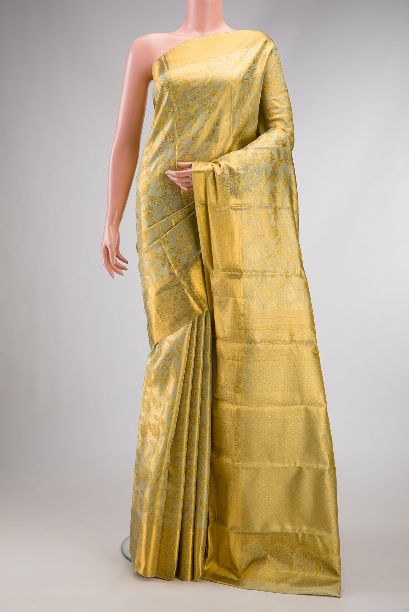 Pista Green Dual Tone Kanchipuram Tissue Silk Saree with Zari Brocade on the body and Zari Border.  displayed on a mannequin
