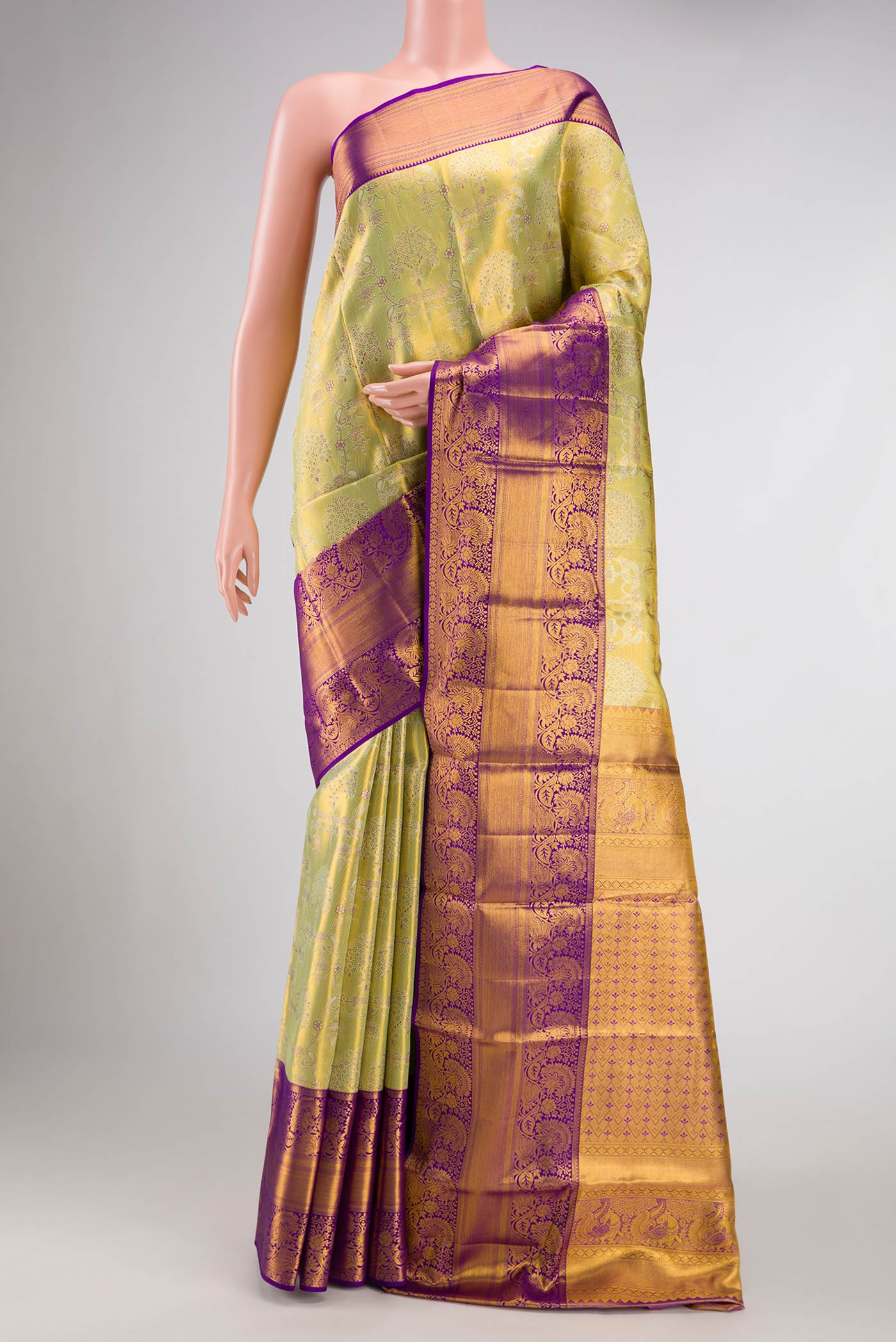 Pista Green Dual Tone Kanchipuram Tissue Silk Saree with Zari Brocade on the body and Zari Border.  displayed on a mannequin