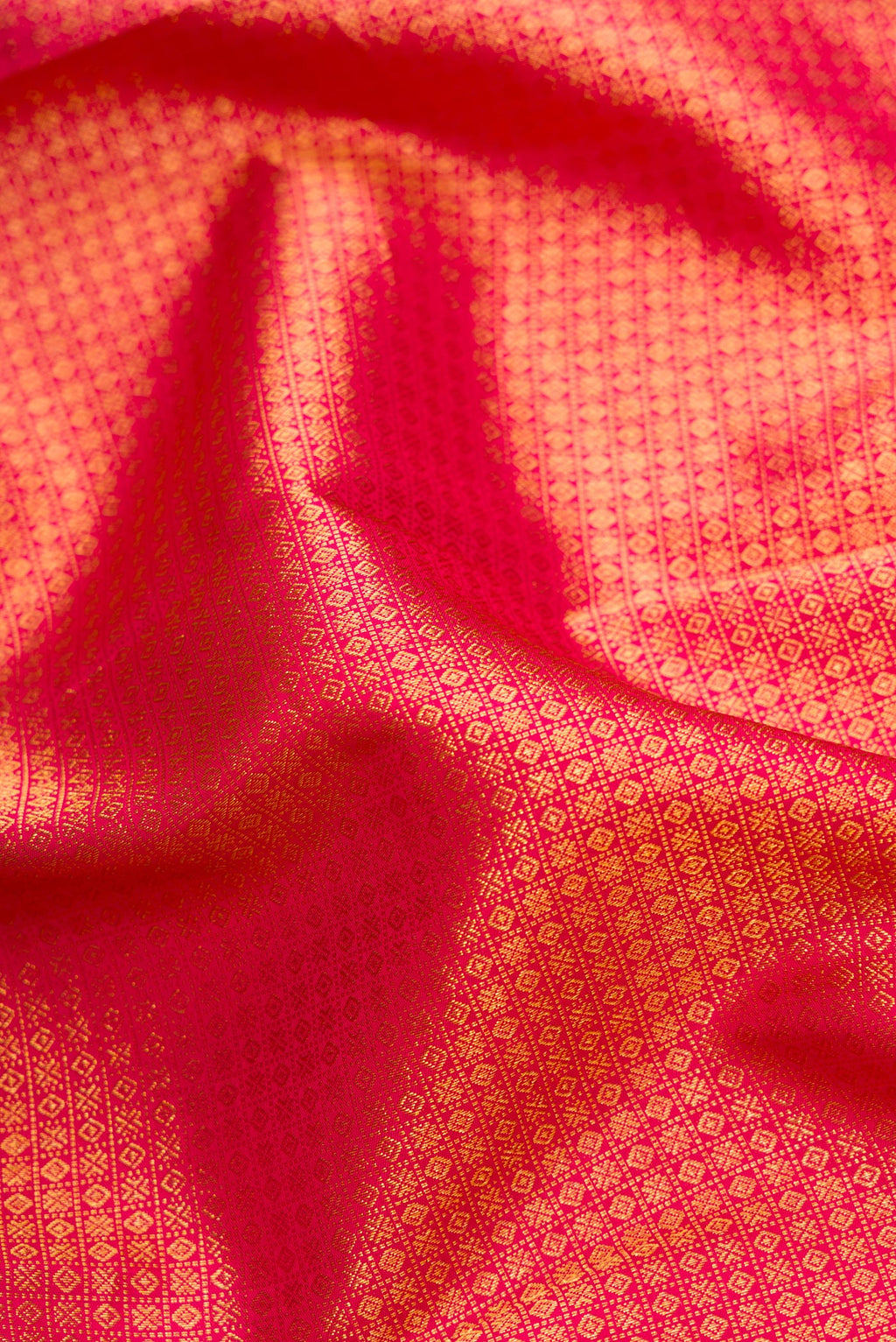 Close up of Red Dual Tone Kanjivaram Silk Saree with Zari Brocade on the body and Zari Border.  displaying folds