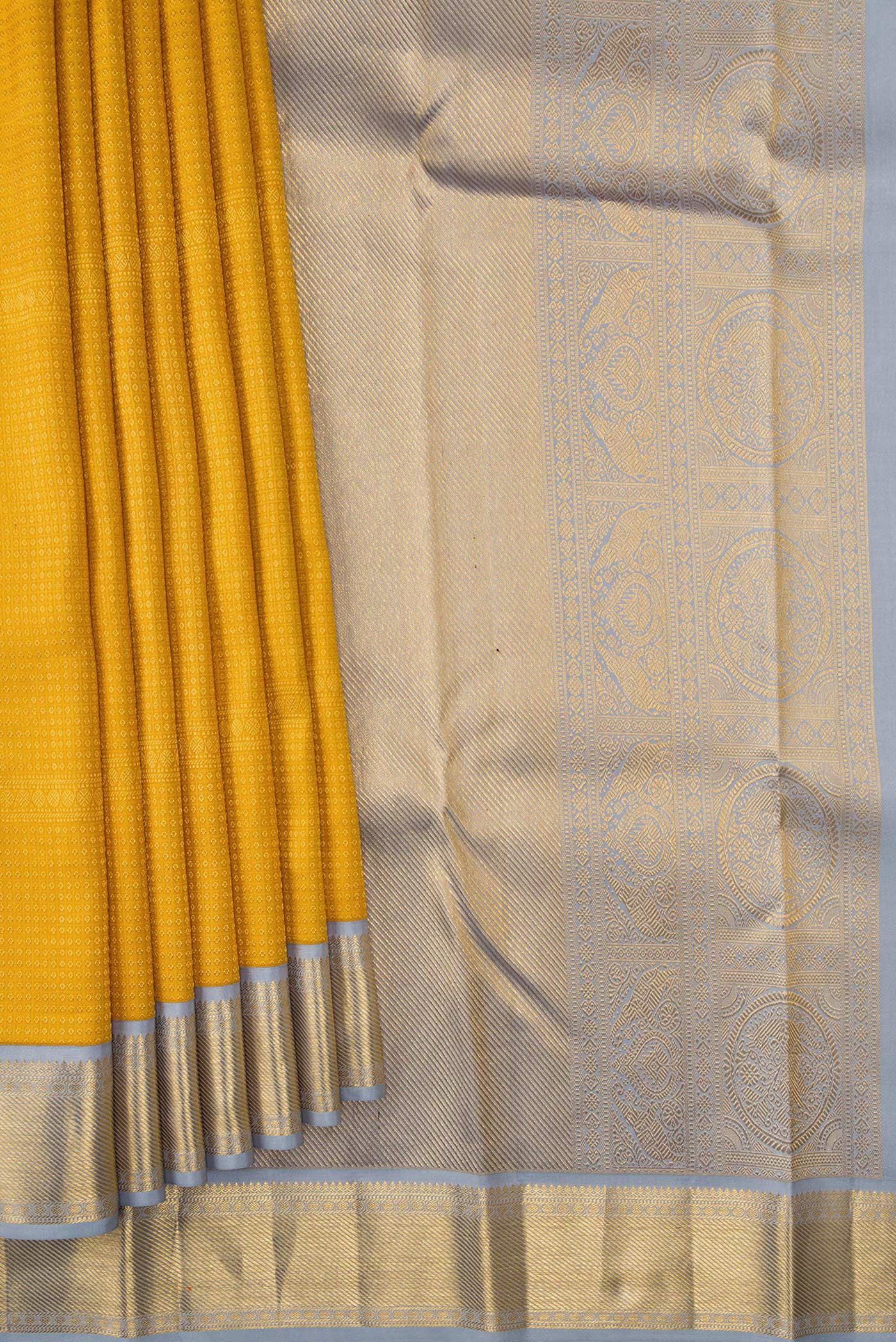 Pleats and pallu of Mustard Dual Tone Kanjivaram Silk Saree with Zari Brocade on the body and Zari Border. 