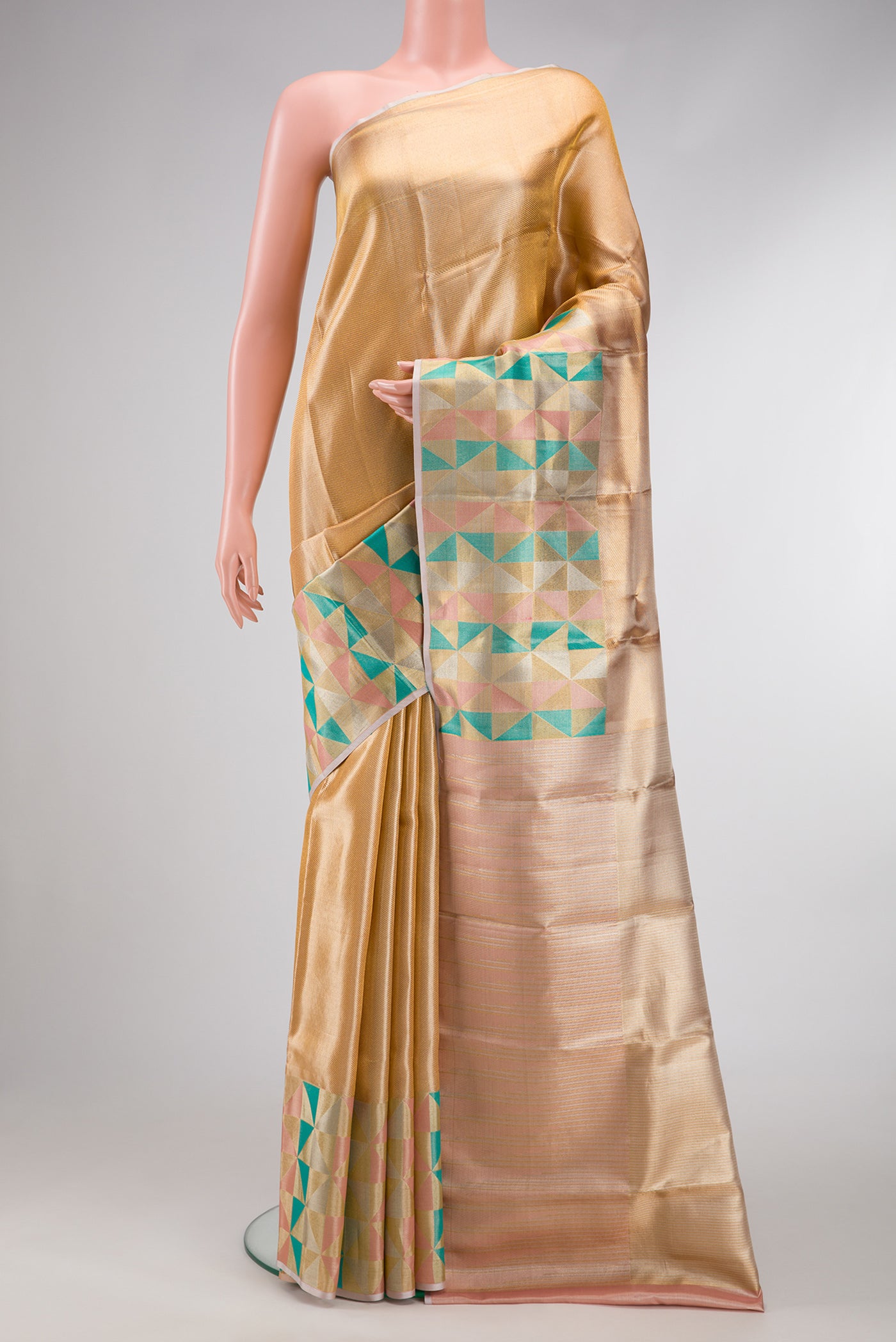 Gold Dual Tone Kanjivaram Tissue Silk Saree with Zari Brocade on the body and Fancy Border.  displayed on a mannequin