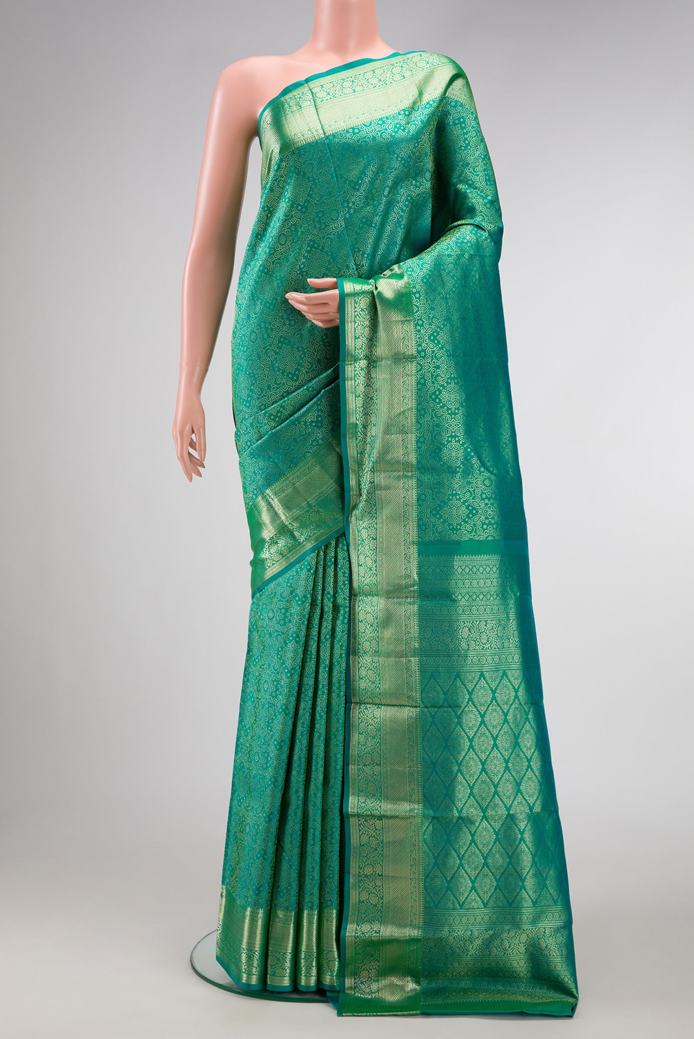 Green Dual Tone Kanchipuram Silk Saree with Zari Brocade on the body and Zari Border.  displayed on a mannequin