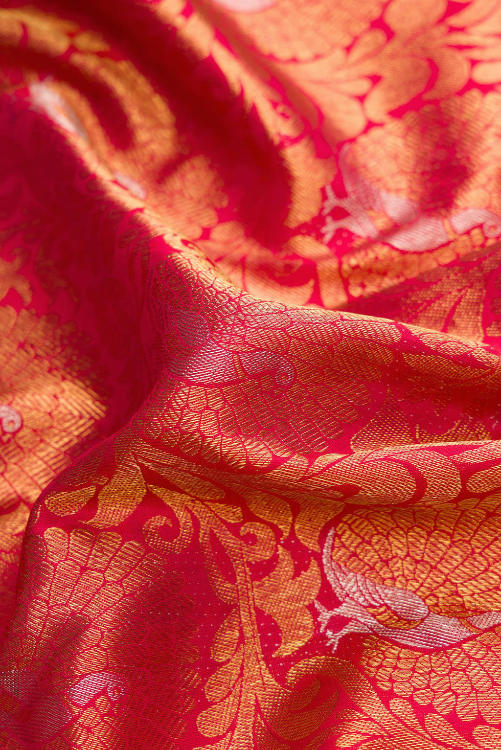 Close up of Pure Silk Pure Zari Dark Pink Dual Tone Kanjivaram Saree with Zari Brocade on the body and Zari Border.  displaying folds