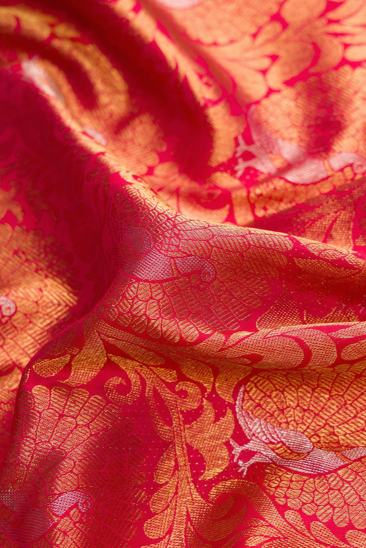Close up of Pure Silk Pure Zari Dark Pink Dual Tone Kanjivaram Saree with Zari Brocade on the body and Zari Border.  displaying folds