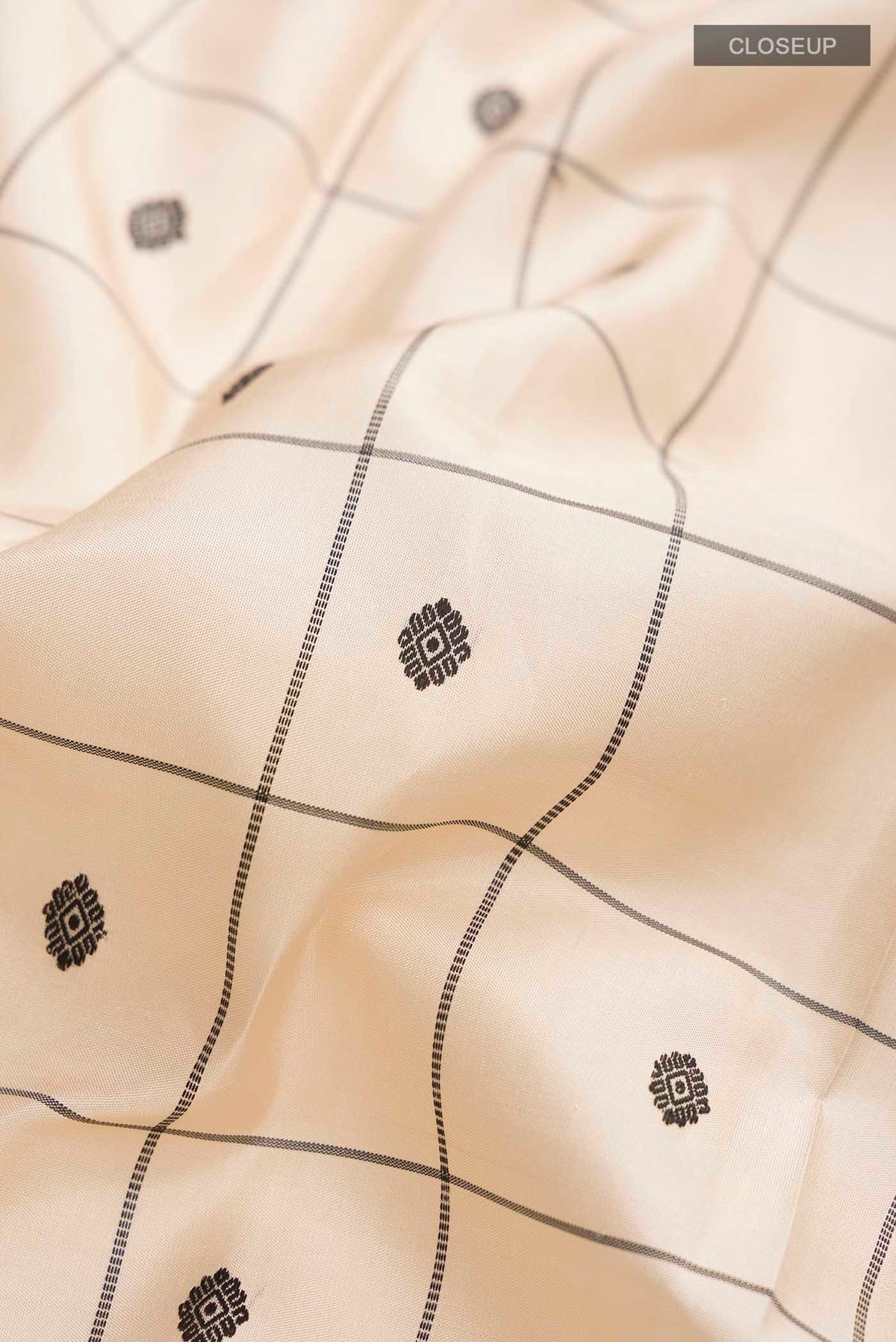 Close up of Sandal Kanchipuram Silk Saree with Checked design on the body and Thread Border displaying folds