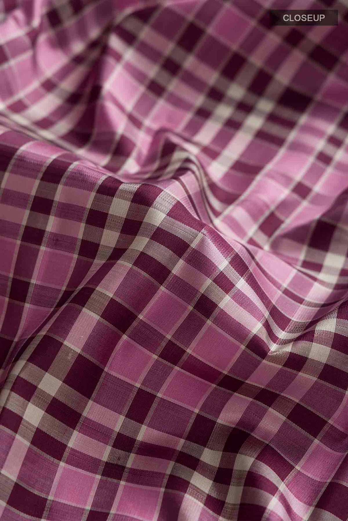 Close up of Multi Color Kanchipuram Silk Saree with Checked design on the body and Plain Border displaying folds