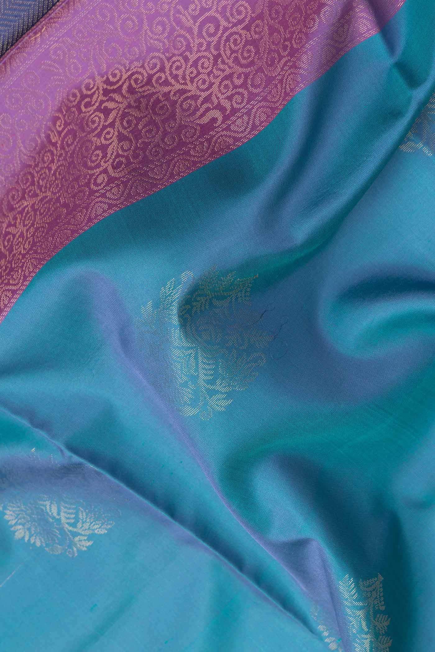Close up of Lavender Dual Tone Soft Silk Saree with Zari Butta on the body and Thin Zari Line.  displaying folds