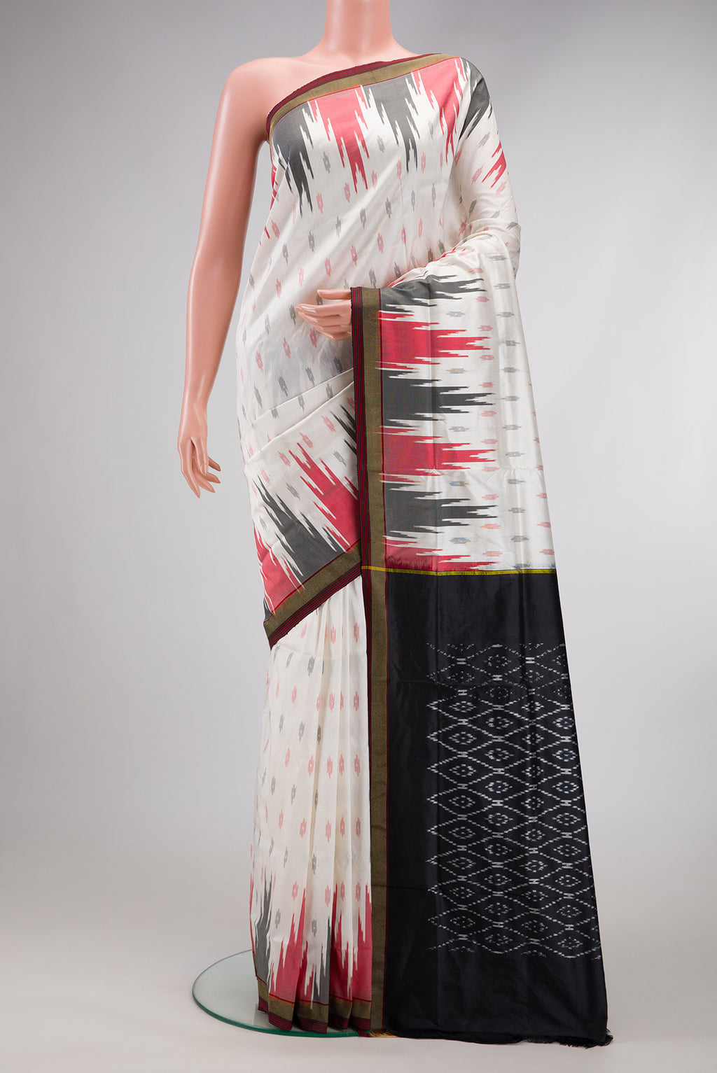 White Double Ikat Saree with Ikat Print on the body and Temple Border.  displayed on a mannequin