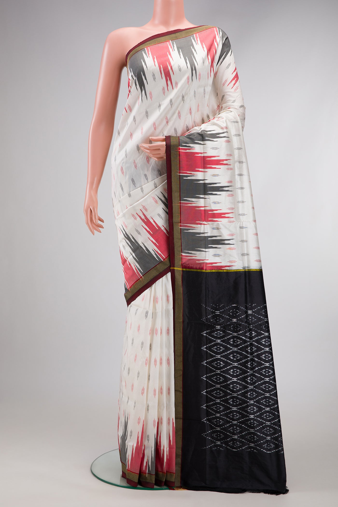 White Double Ikat Saree with Ikat Print on the body and Temple Border.  displayed on a mannequin