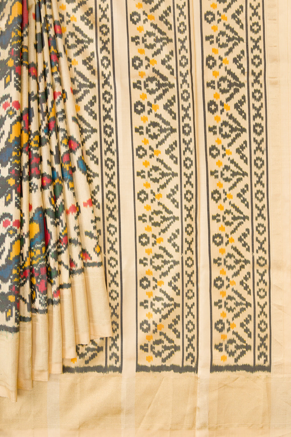 Pleats and pallu of Sandal Dual Tone Double Ikat Saree with Ikat Print on the body and Zari Border. 