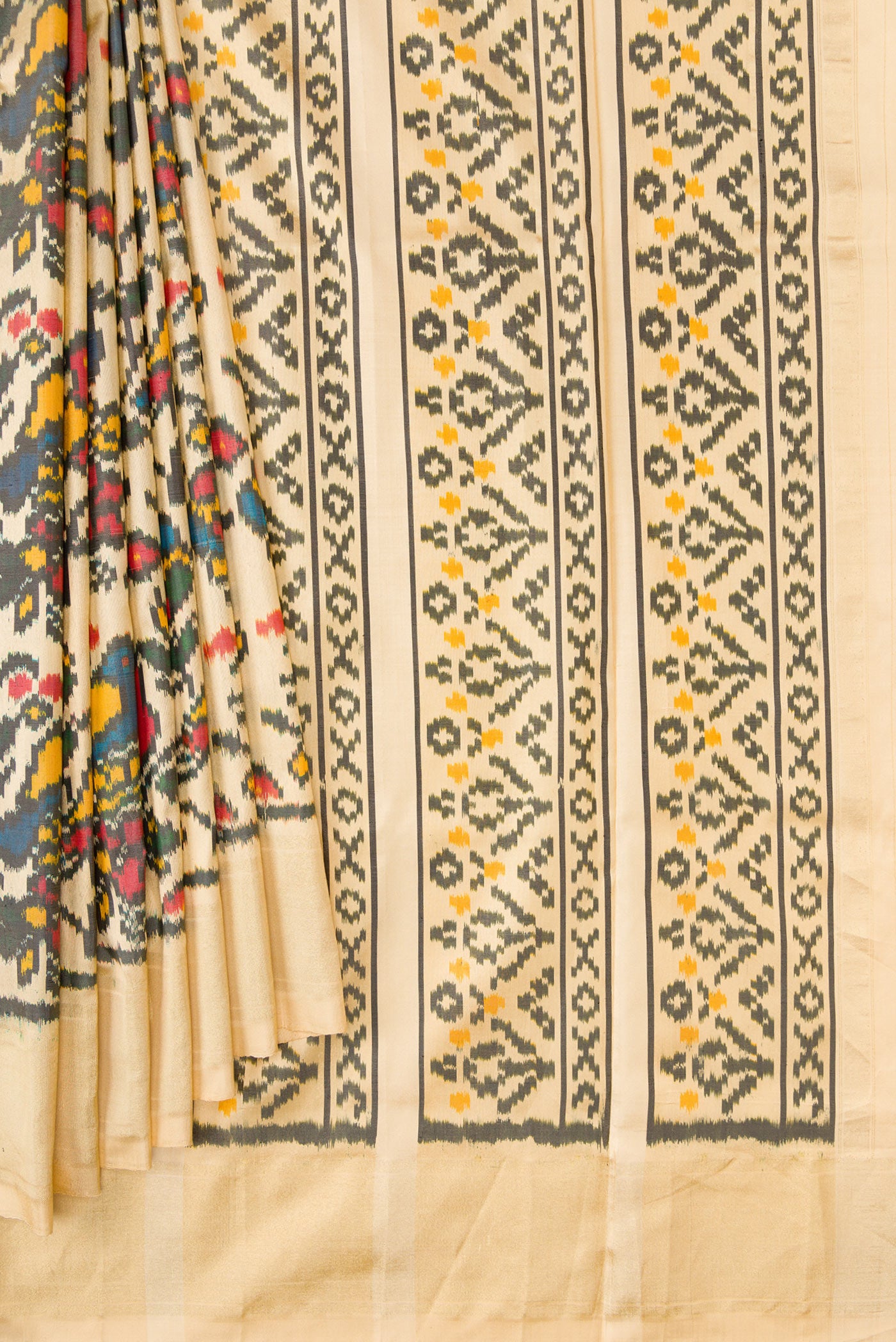 Pleats and pallu of Sandal Dual Tone Double Ikat Saree with Ikat Print on the body and Zari Border. 