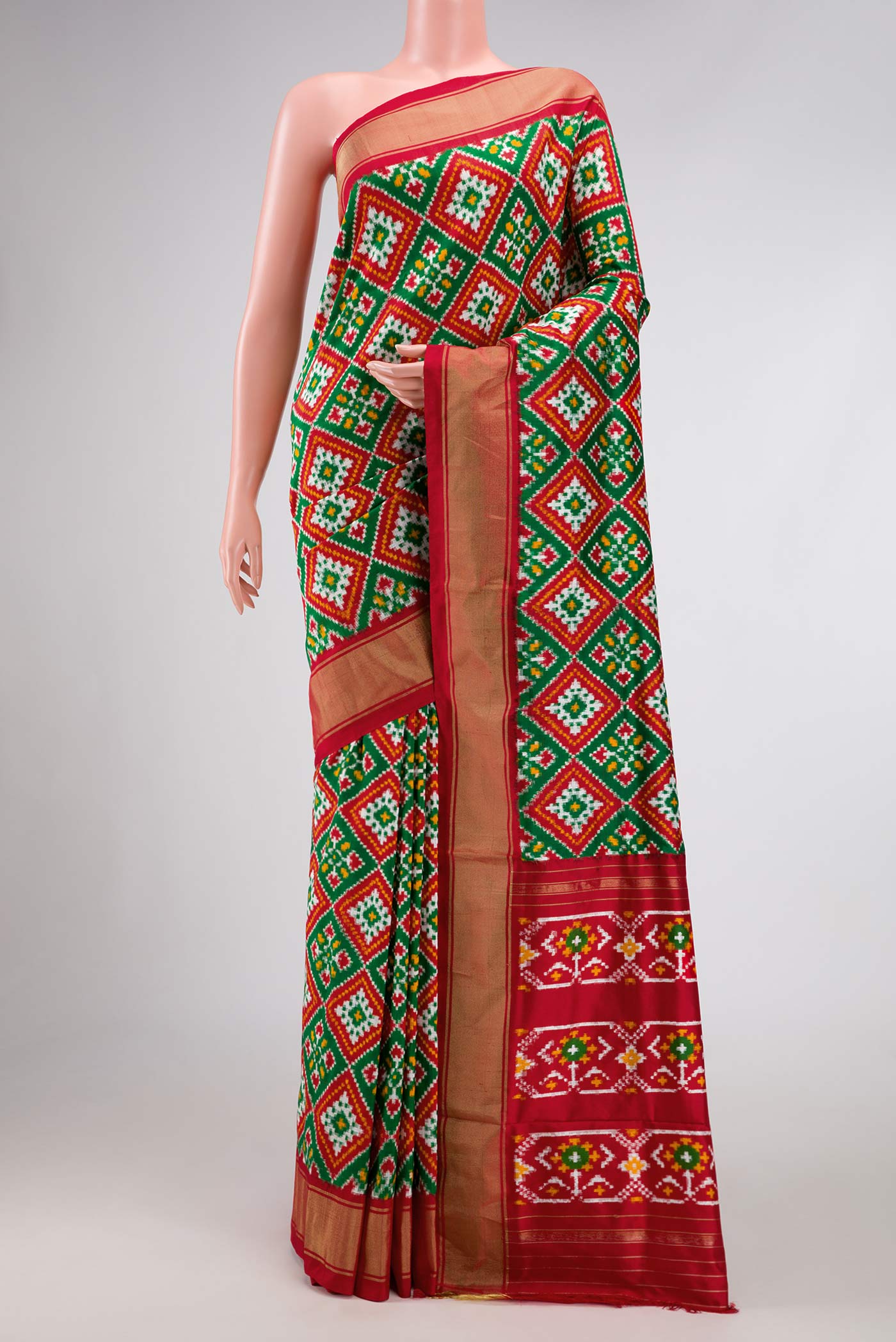 Green Pochampally Silk Saree with Pure Ikat on the body and Zari Border displayed on a mannequin