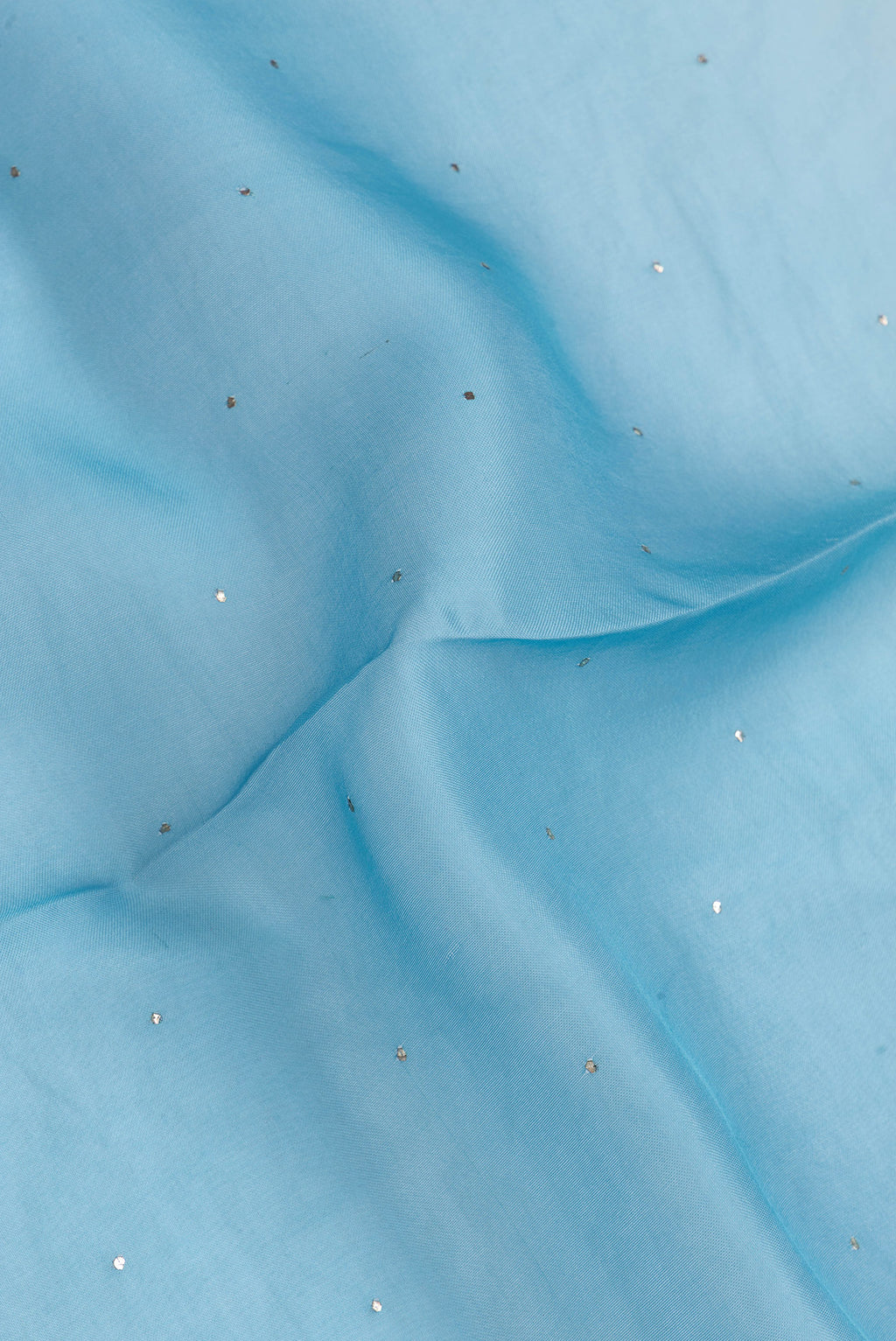 Close up of Sky Blue Dual Tone Organza Silk Saree with Embroidery on the body and Embroidery Border.  displaying folds