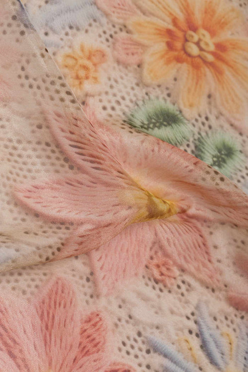 Close up of Beige Dual Tone Organza Silk Saree with Printed design on the body and Embroidery Border displaying folds