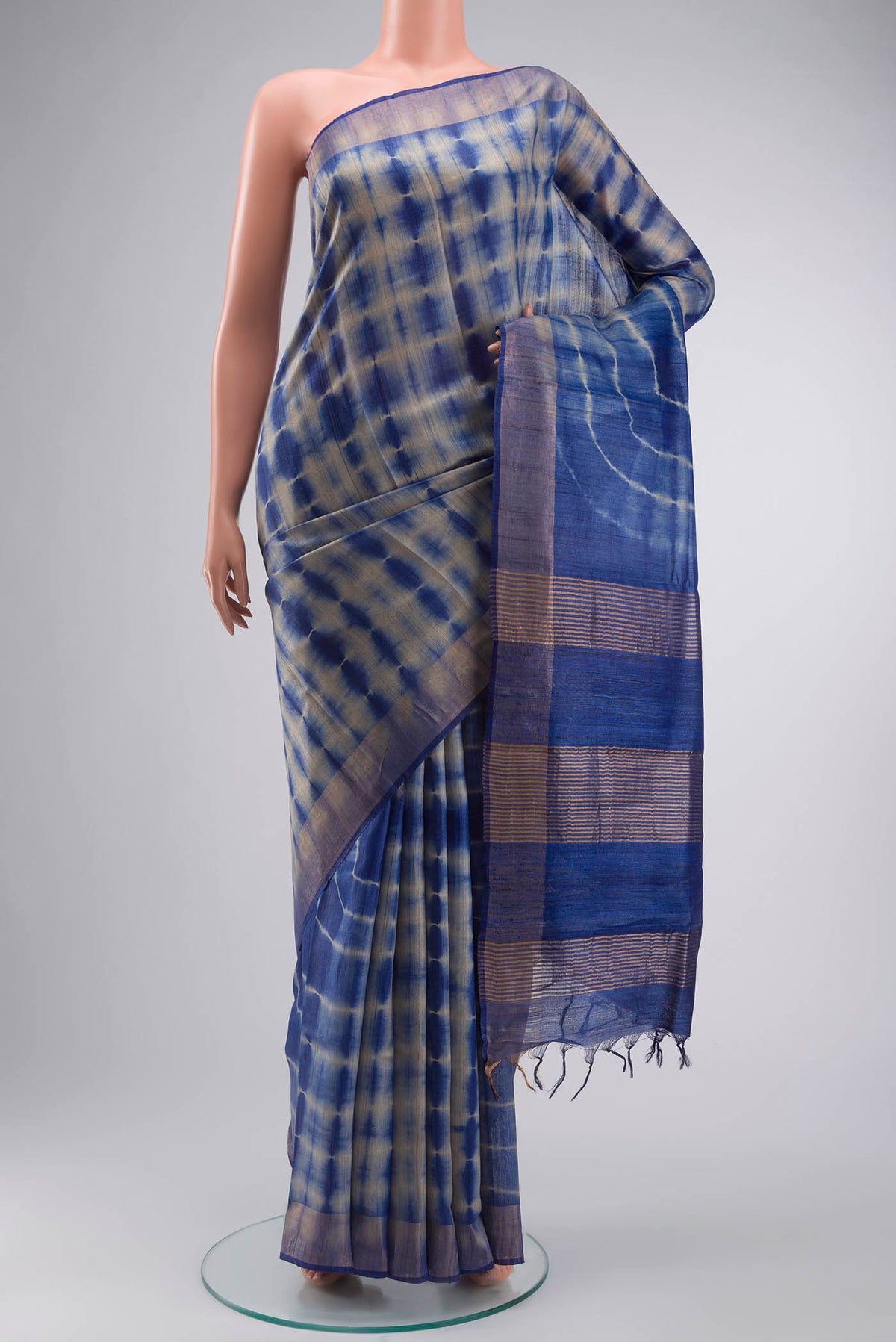 Blue Tussar Silk Saree with Printed design on the body and Zari Border displayed on a mannequin