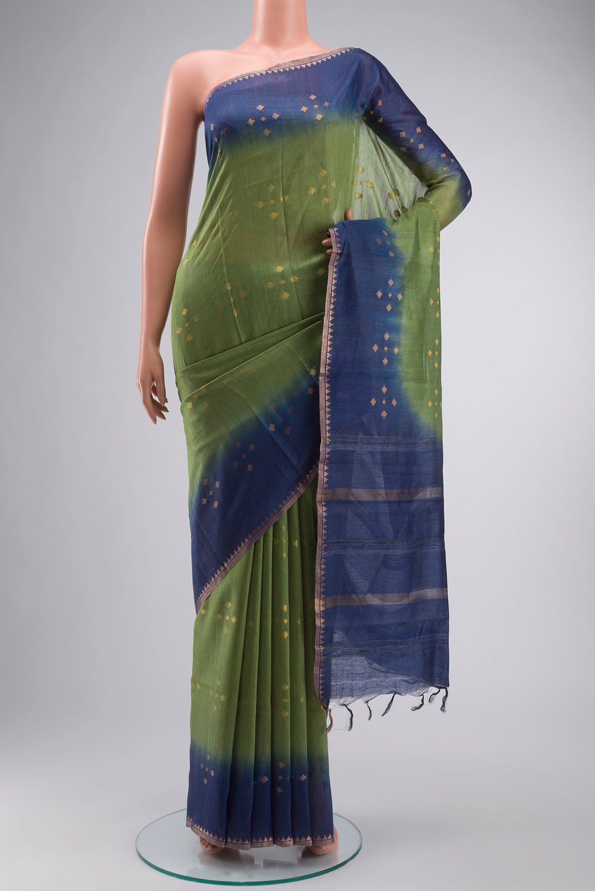 Green Tussar Silk Saree with Zari Butta on the body and Zari Border displayed on a mannequin