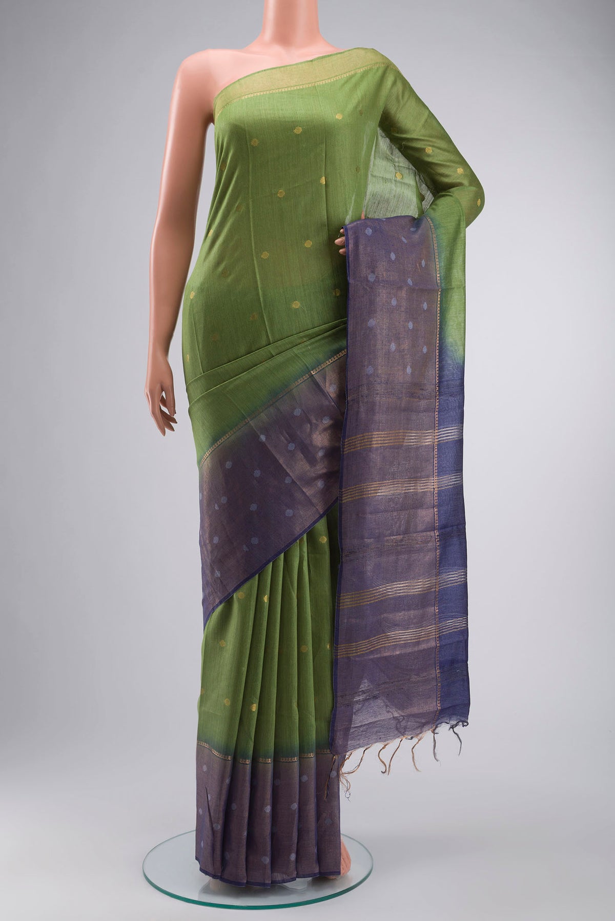 Green Tussar Silk Saree with Zari Butta on the body and Zari Border displayed on a mannequin