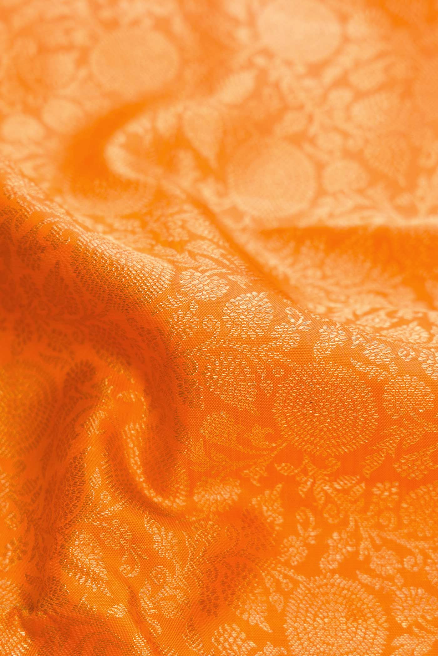 Close up of Orange Dual Tone Kanchipuram Silk Saree with Zari Brocade on the body and Zari Border.  displaying folds
