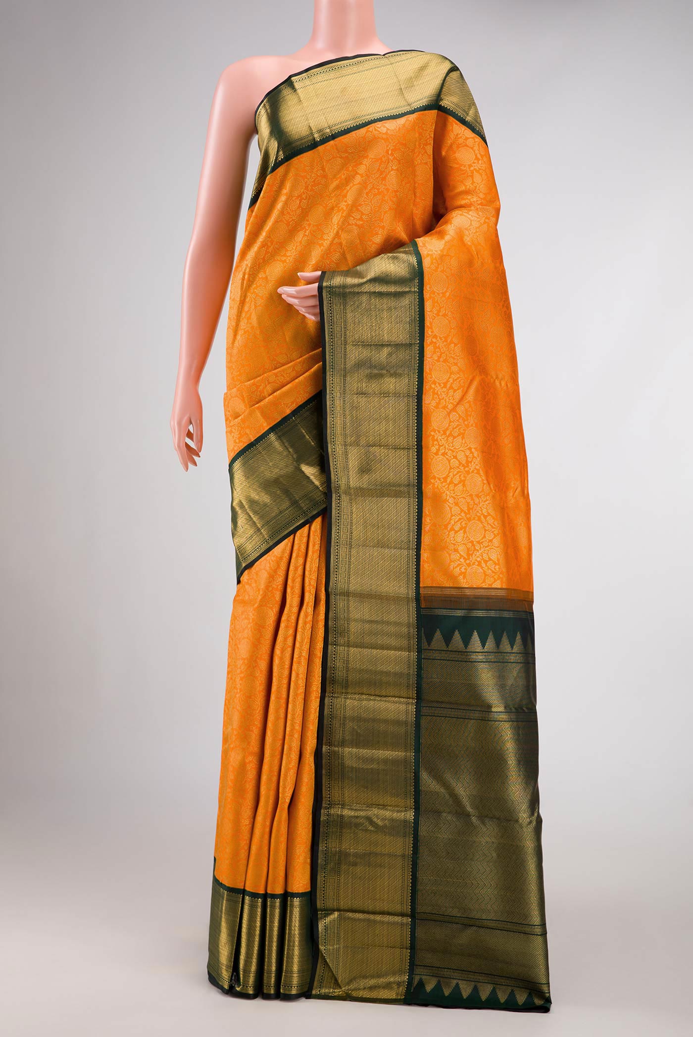 Orange Dual Tone Kanchipuram Silk Saree with Zari Brocade on the body and Zari Border.  displayed on a mannequin