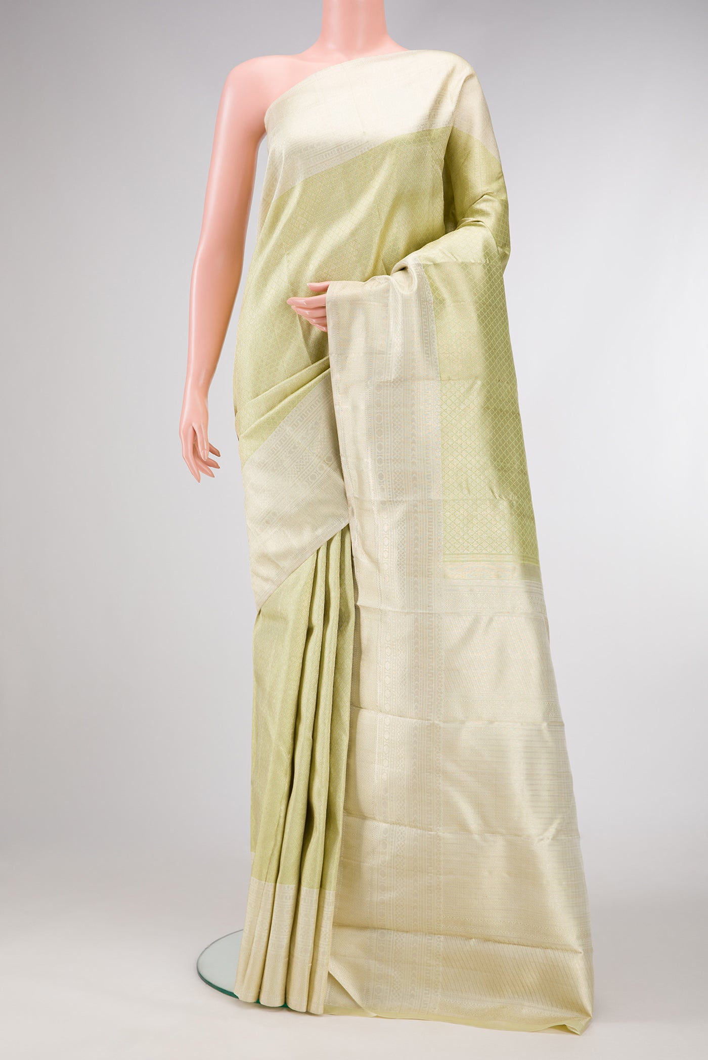 Pista Green Dual Tone Kanchipuram Silk Saree with Zari Brocade on the body and Zari Border.  displayed on a mannequin