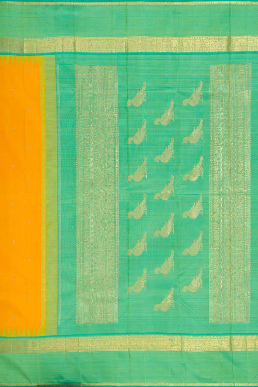 Close up image of the pallu of Yellow Kanchipuram Silk Saree with Zari Butta on the body and Zari Border. 