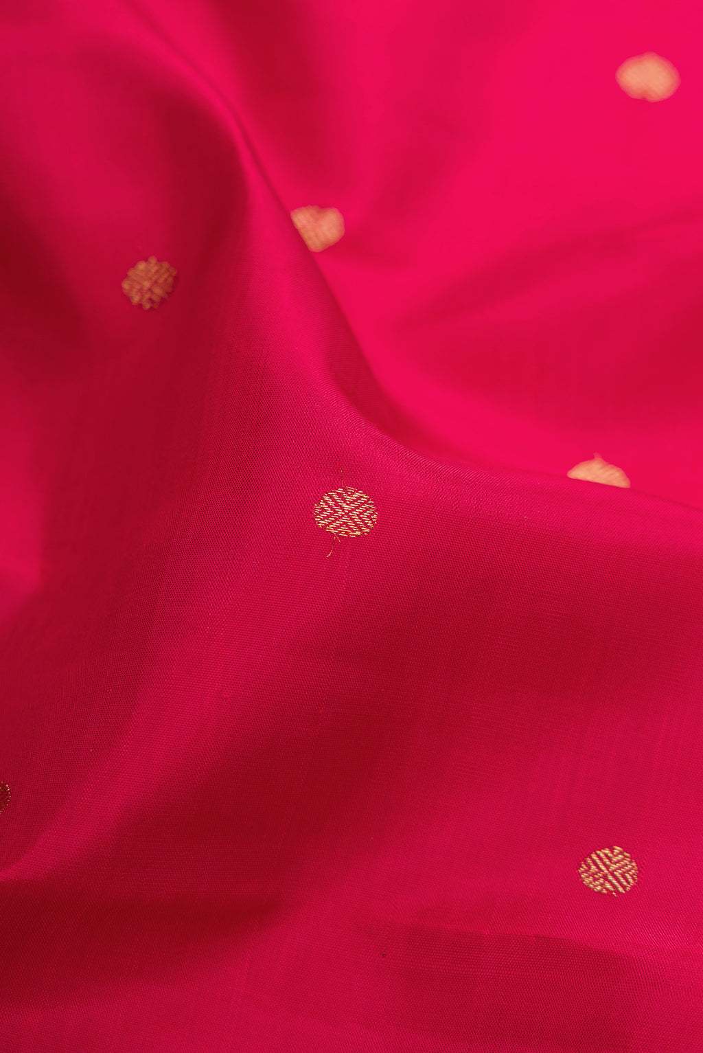 Close up of Pure Silk Pure Zari Red Kanchipuram Saree with Zari Butta on the body and Zari Border.  displaying folds