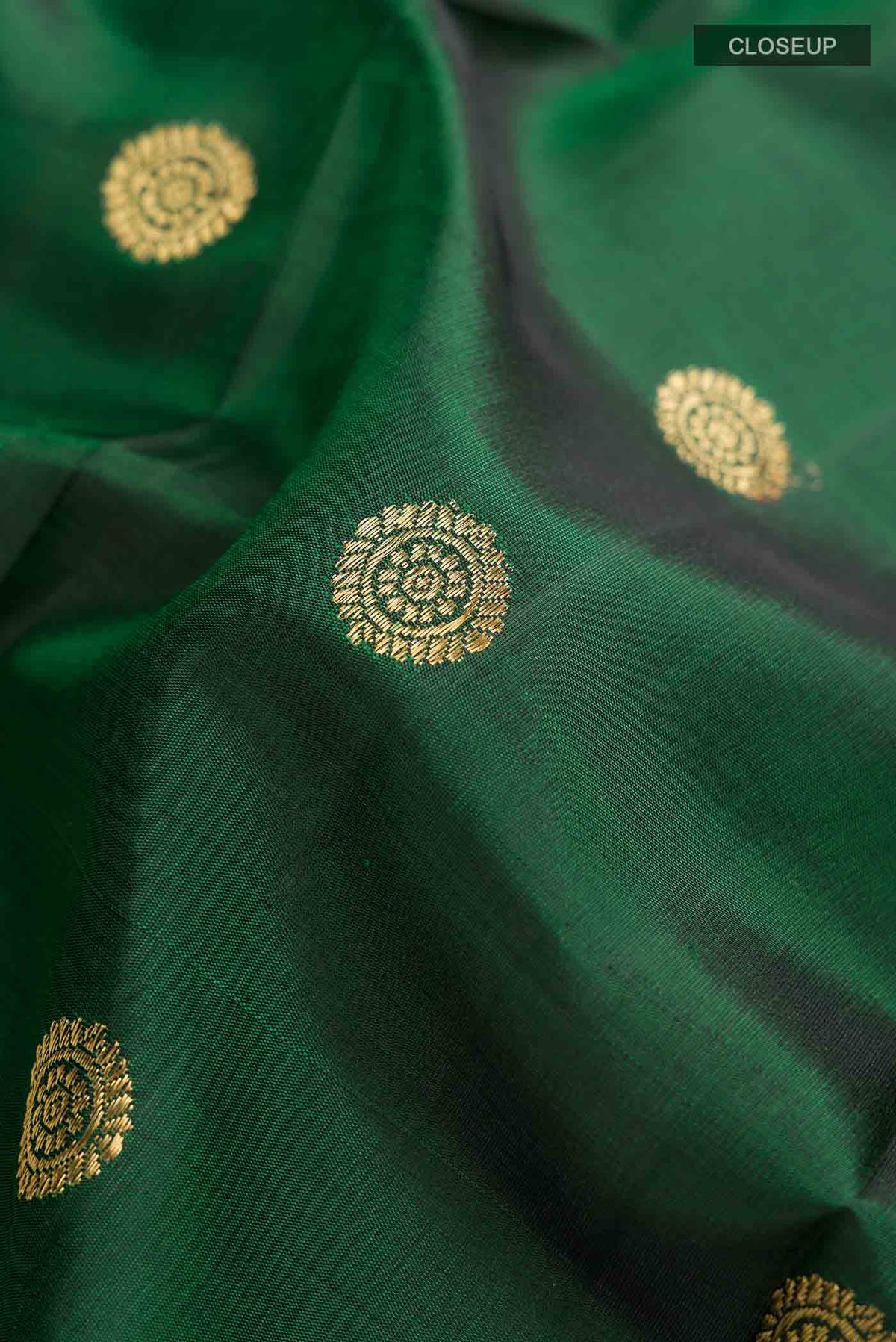 Close up of Green Paithani Silk Saree with Zari Butta on the body and Zari Border displaying folds