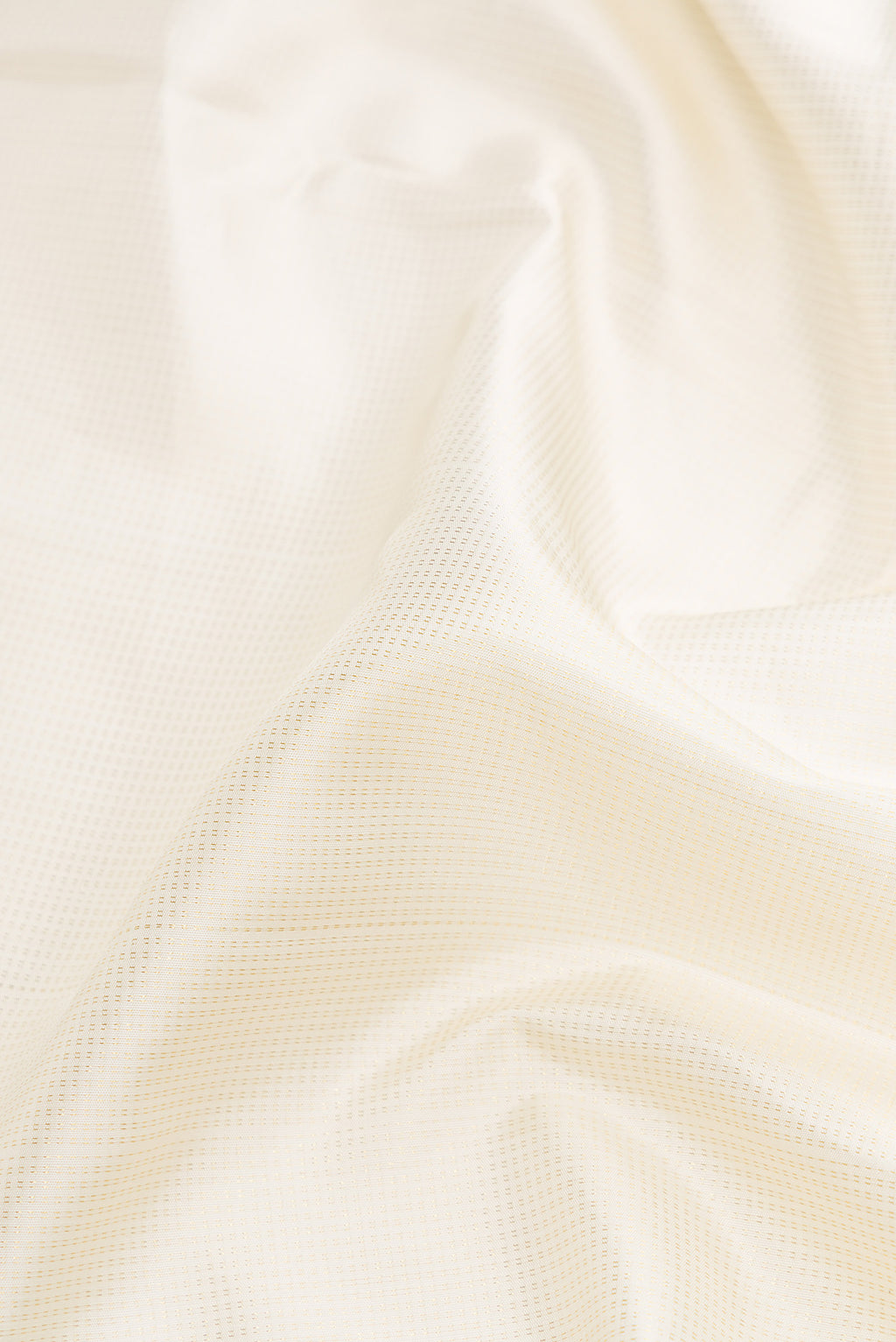 Close up of Pure Silk Pure Zari Off White Dual Tone Kanchipuram Nine Yards Saree with Zari Brocade on the body and Zari Border.  displaying folds