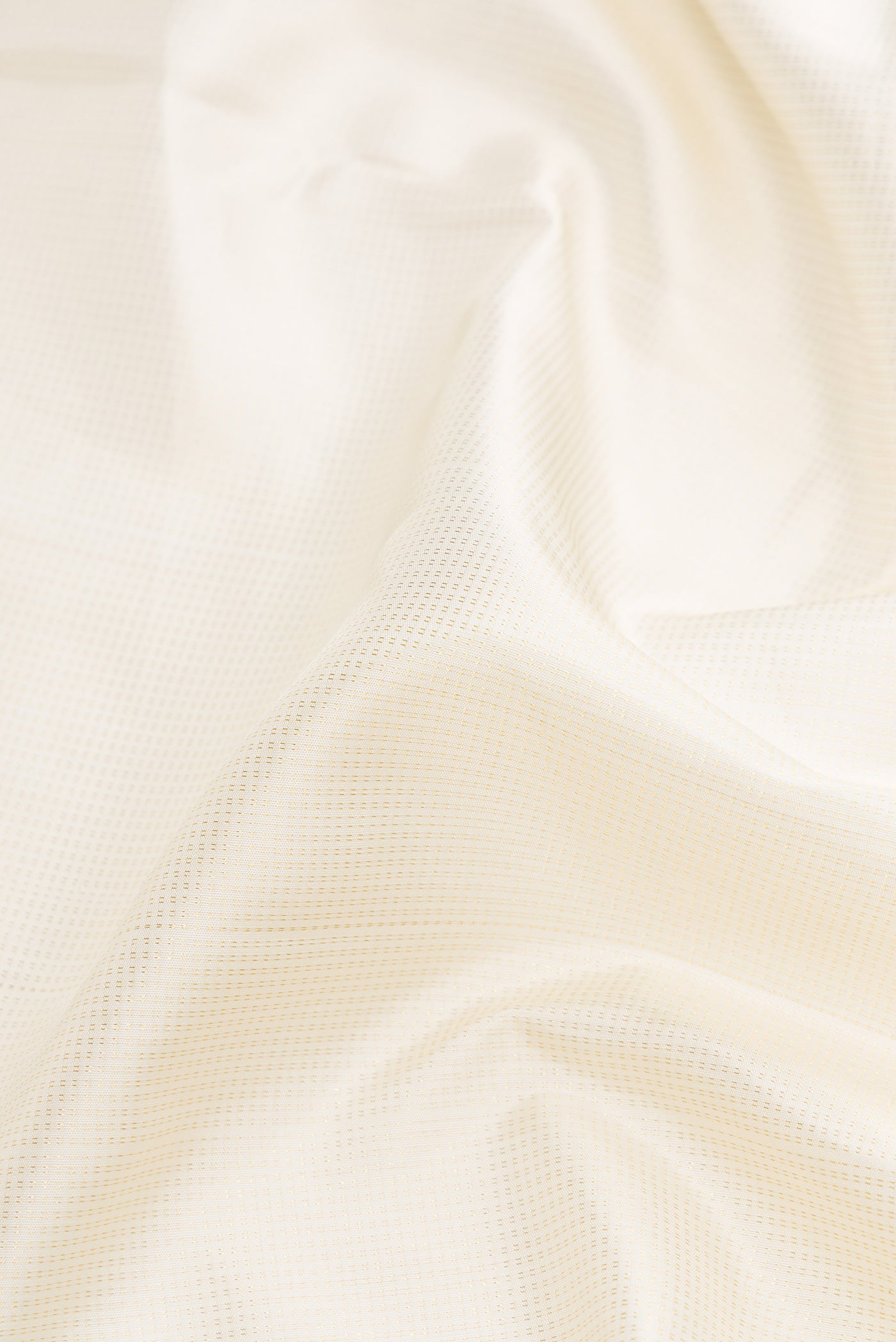 Close up of Pure Silk Pure Zari Off White Dual Tone Kanchipuram Nine Yards Saree with Zari Brocade on the body and Zari Border.  displaying folds