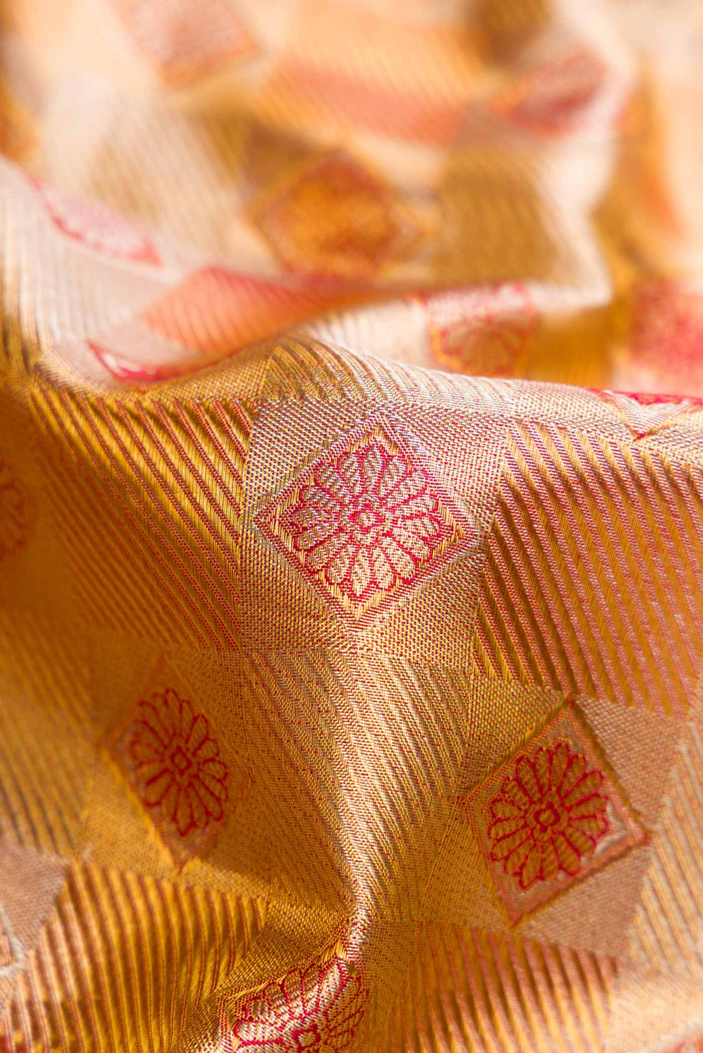 Close up of Gold Dual Tone Kanchipuram Tissue Silk Saree with Zari Brocade on the body and Zari Border.  displaying folds