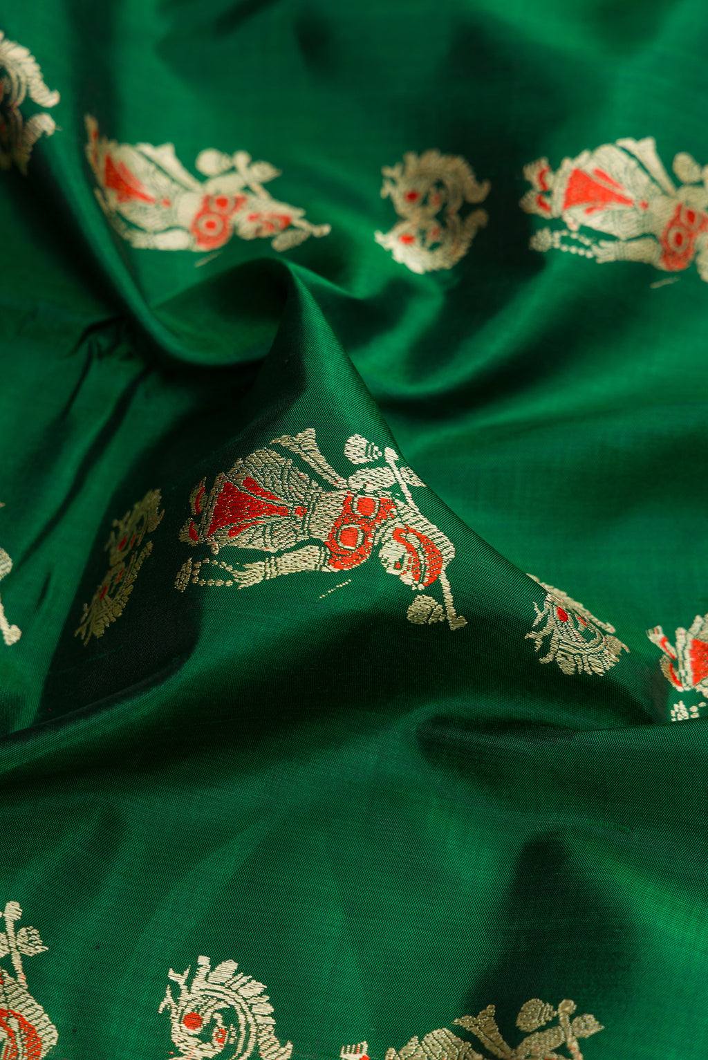 Close up of Bottle Green Dual Tone Baluchari Silk Saree with Thread Butta on the body and Thread Border.  displaying folds