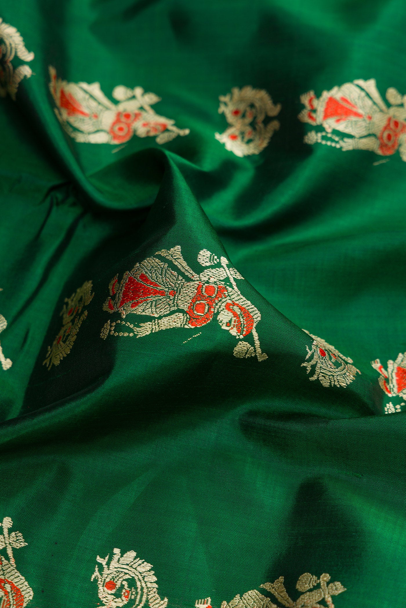 Close up of Bottle Green Dual Tone Baluchari Silk Saree with Thread Butta on the body and Thread Border.  displaying folds