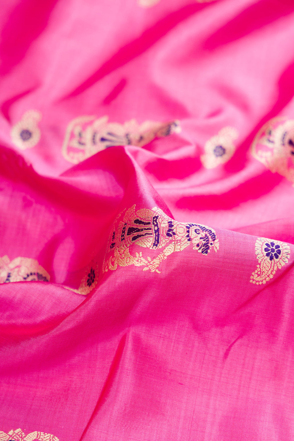 Close up of Pink Baluchari Silk Saree with Thread Butta on the body and Fancy Border.  displaying folds