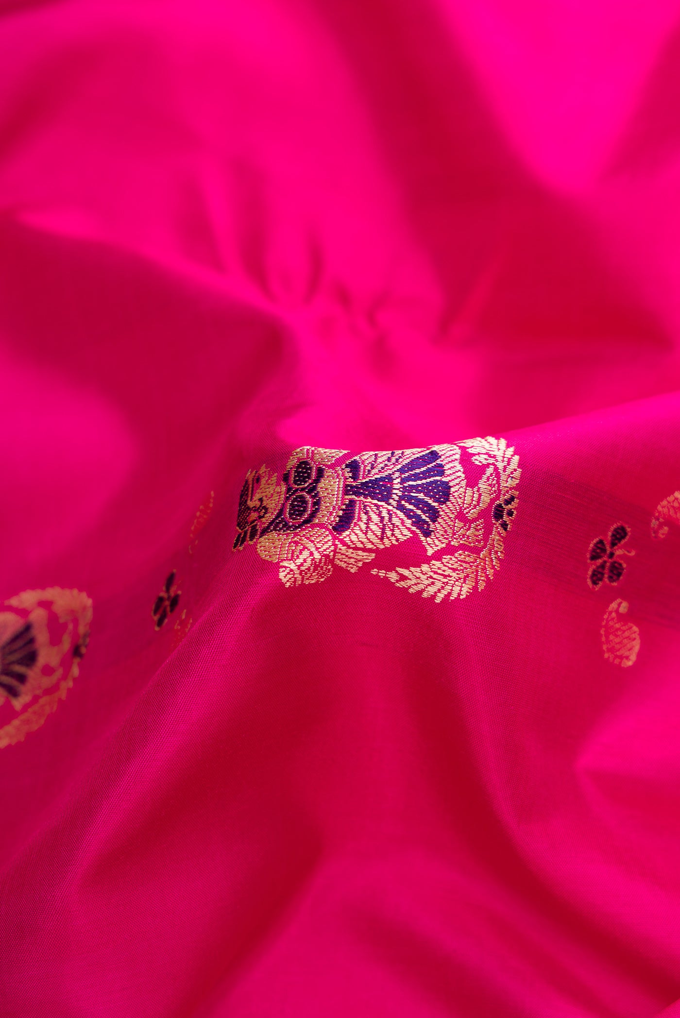 Close up of Pink Dual Tone Baluchari Silk Saree with Thread Butta on the body and Thread Border.  displaying folds