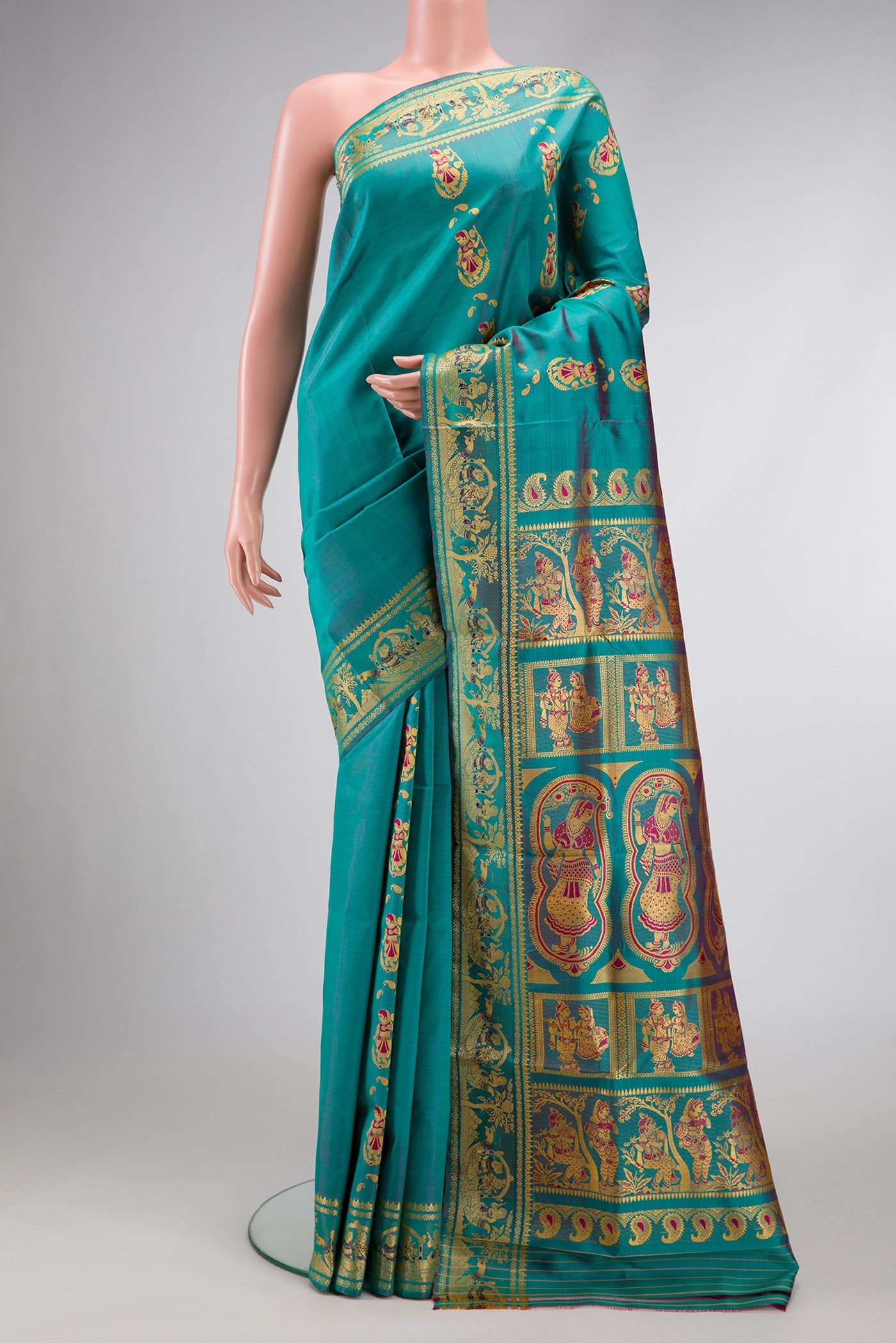 Peacock Blue Dual Tone Baluchari Silk Saree with Thread Butta on the body and Fancy Border.  displayed on a mannequin