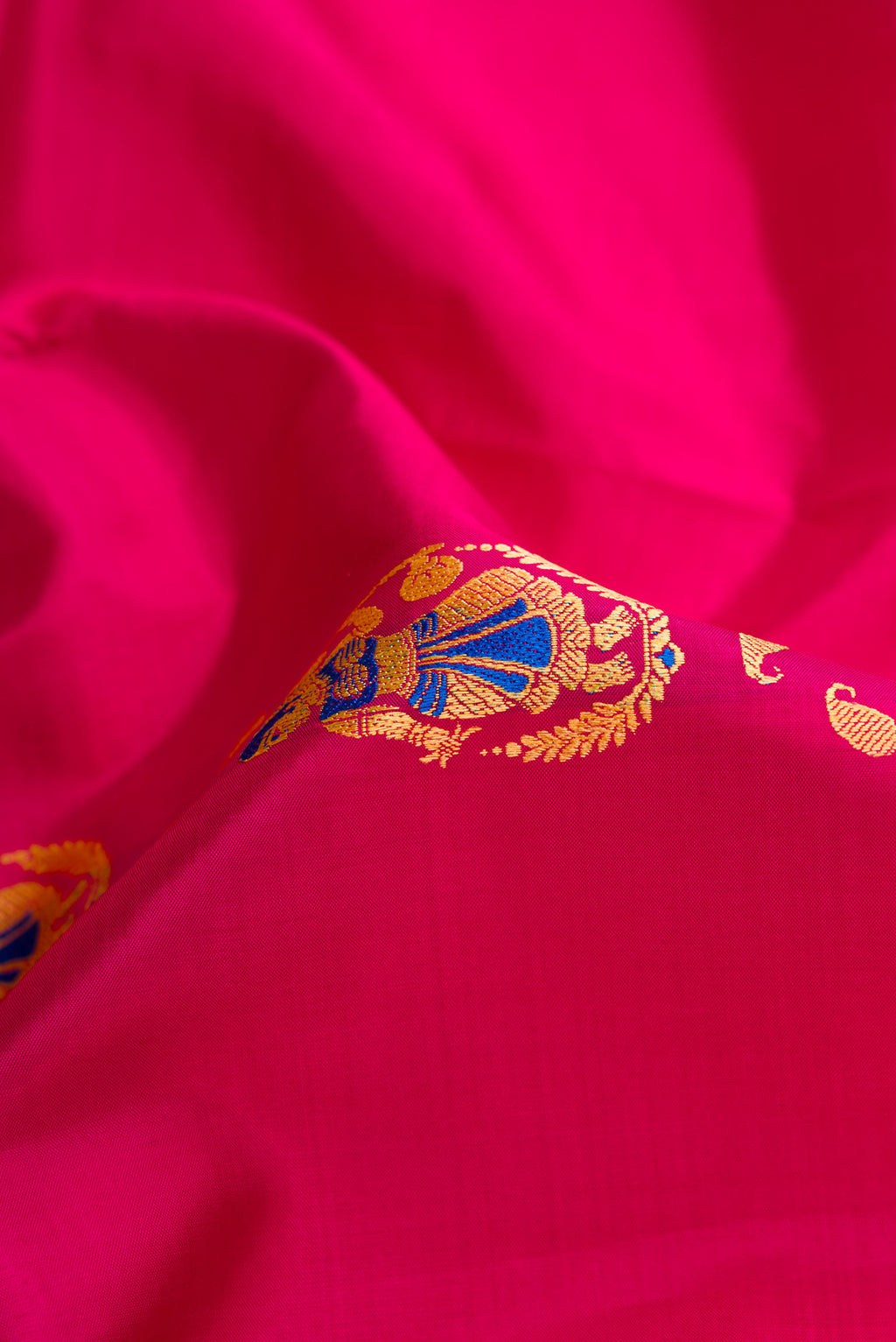 Close up of Pink Dual Tone Baluchari Silk Saree with Thread Butta on the body and Thread Border.  displaying folds